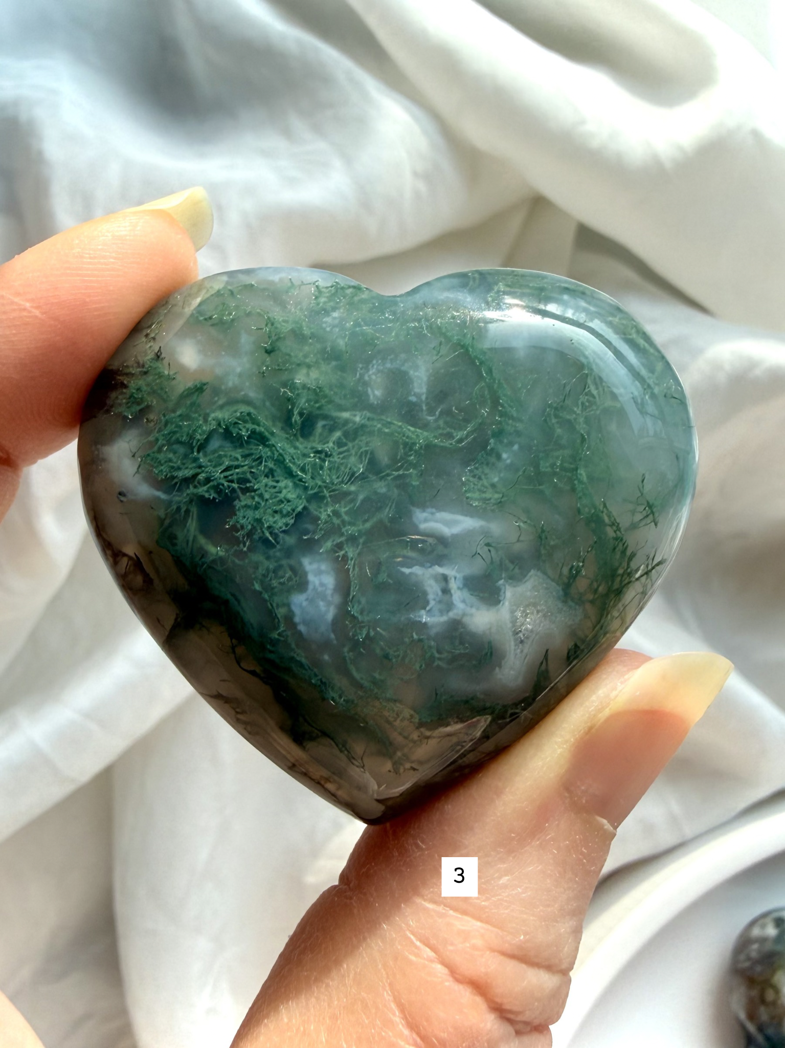 moss agate heart carving option 3 in hand with detailed moss pattern and soft white chalcedony banding