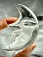 Close-up of Clear Quartz Moon Face carving highlighting detailed facial features and luminous transparent crystal