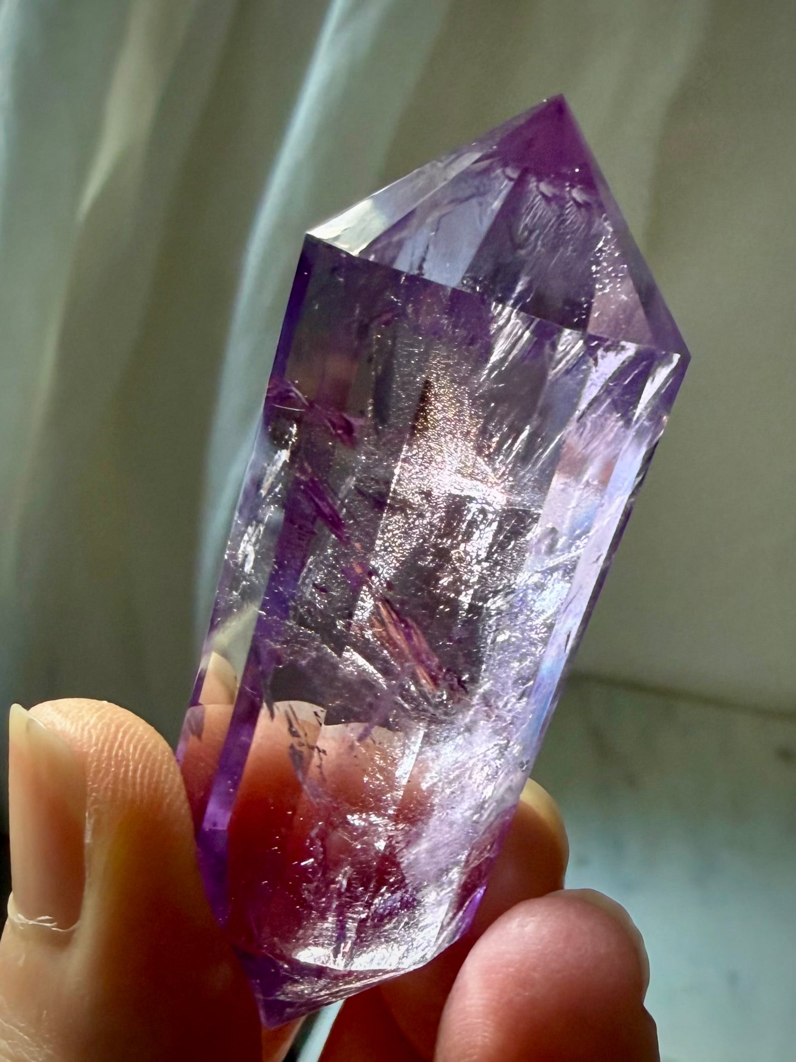 Amethyst Vogel cut crystal wand with high clarity, rich violet color, and rainbow flashes