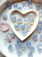 Blue Chalcedony heart stones arranged in a heart dish for crystal rituals, calming gemstones for communication and emotional balance