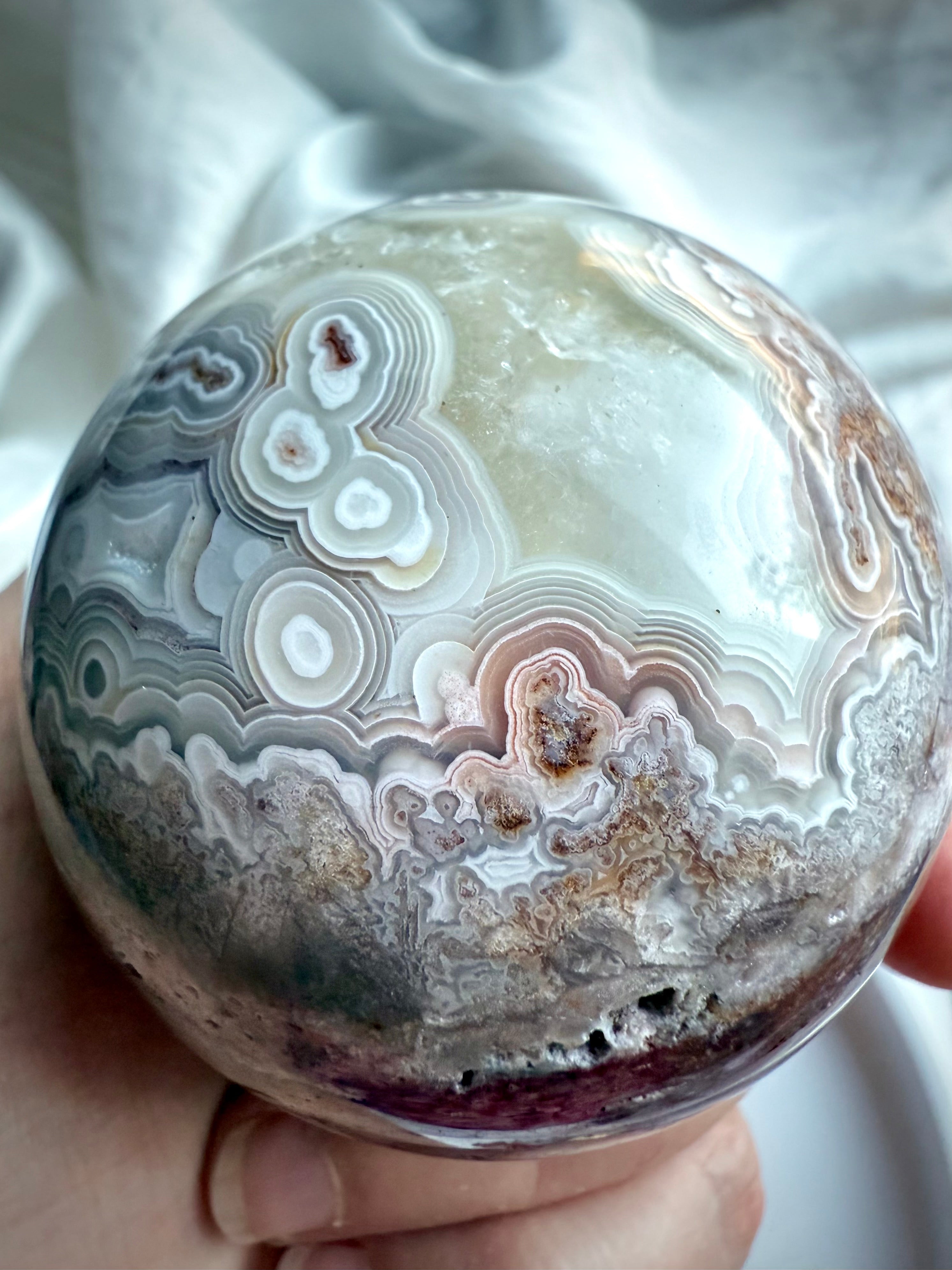 Crazy Lace Agate sphere with lavender and mauve tones, intricate lace-like banding, and natural druzy textures