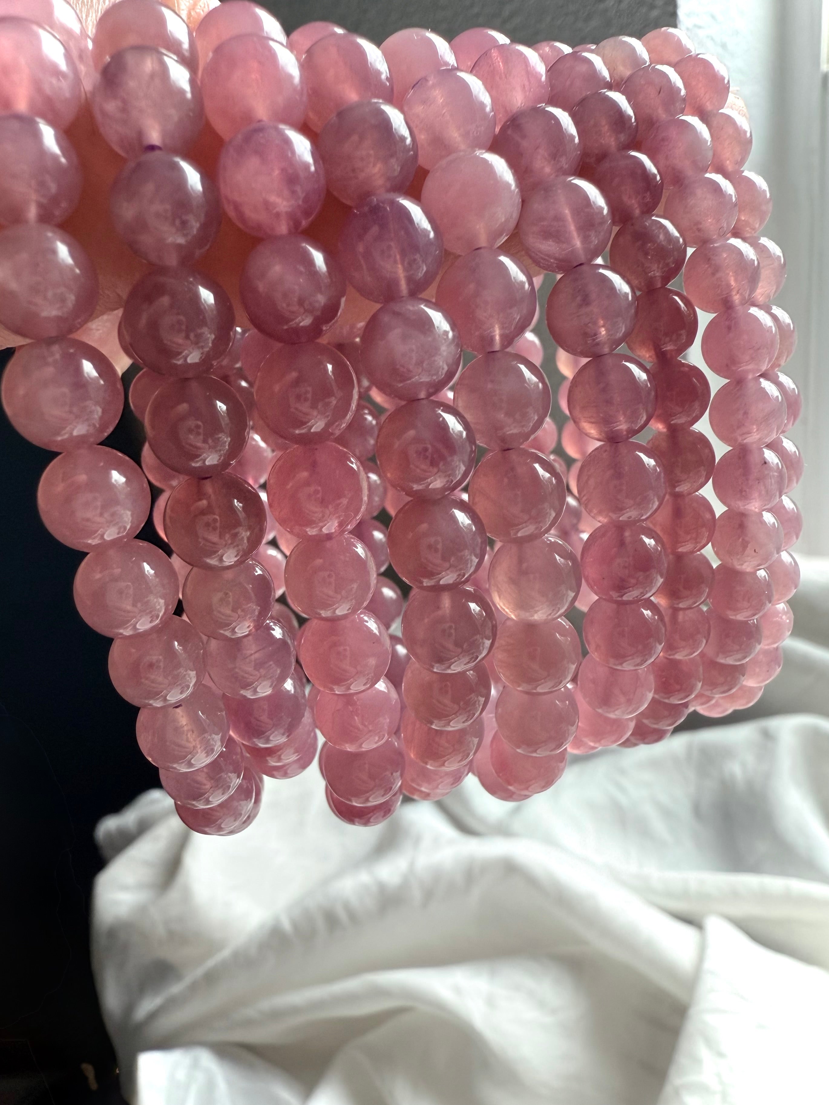 Stacked Lavender Rose Quartz Bracelets showing soft pink, lilac, and lavender gemstone beads with natural translucency