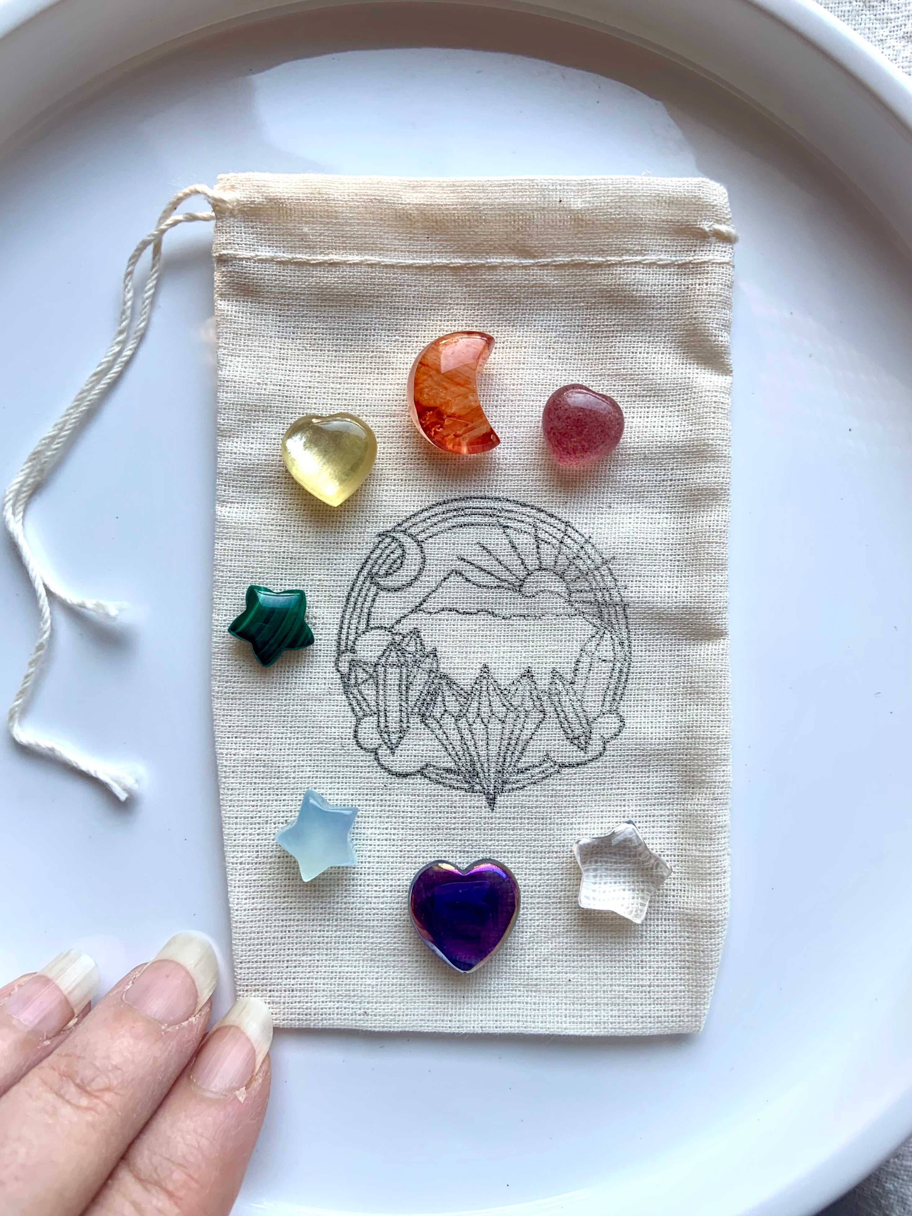 Chakra crystal set with 7 mini carved gems — heart, moon & star shapes in rainbow colors with pouch