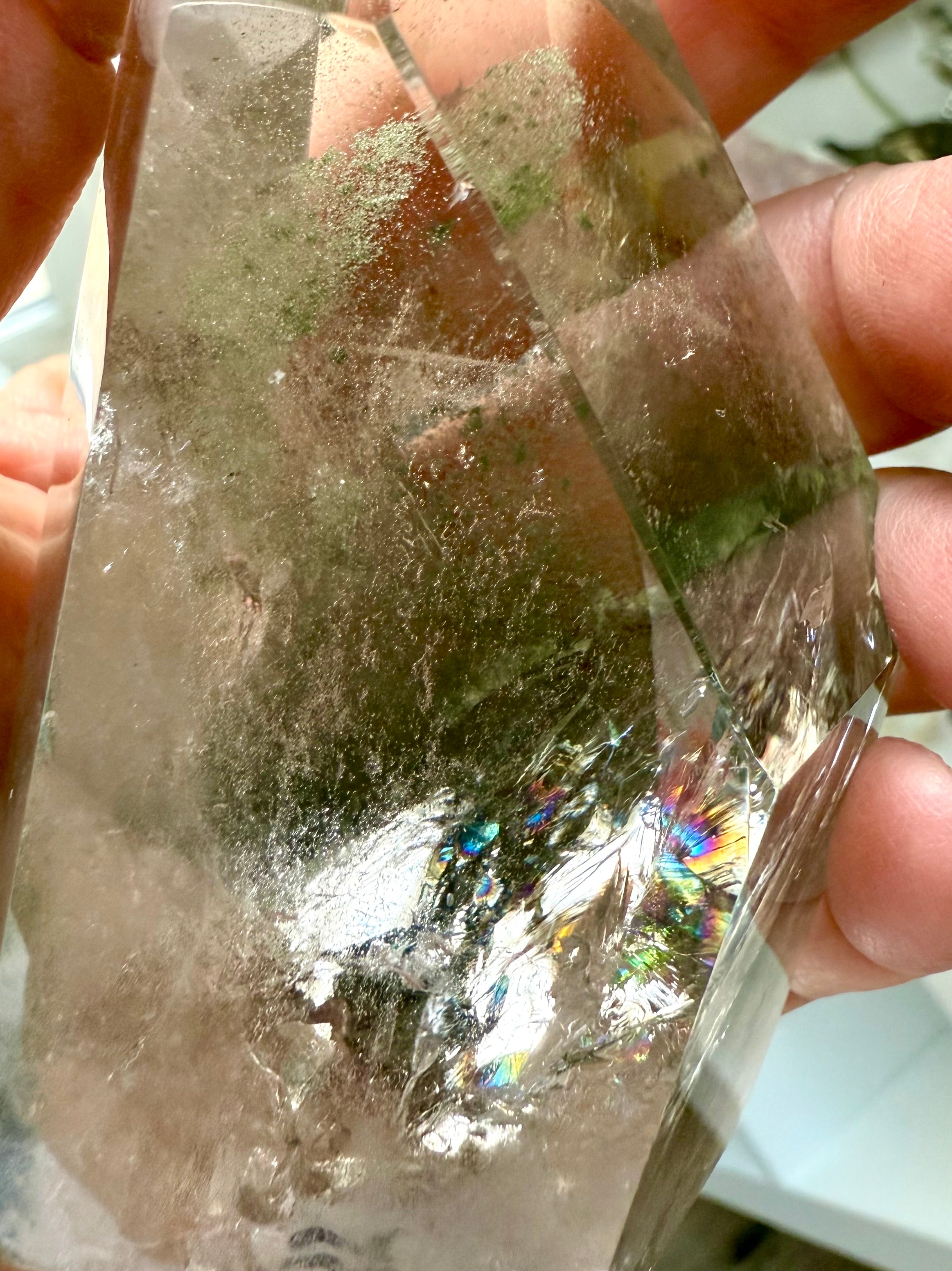 Close up of Garden Quartz tower from Brazil with vivid green chlorite inclusions and rainbow flashes