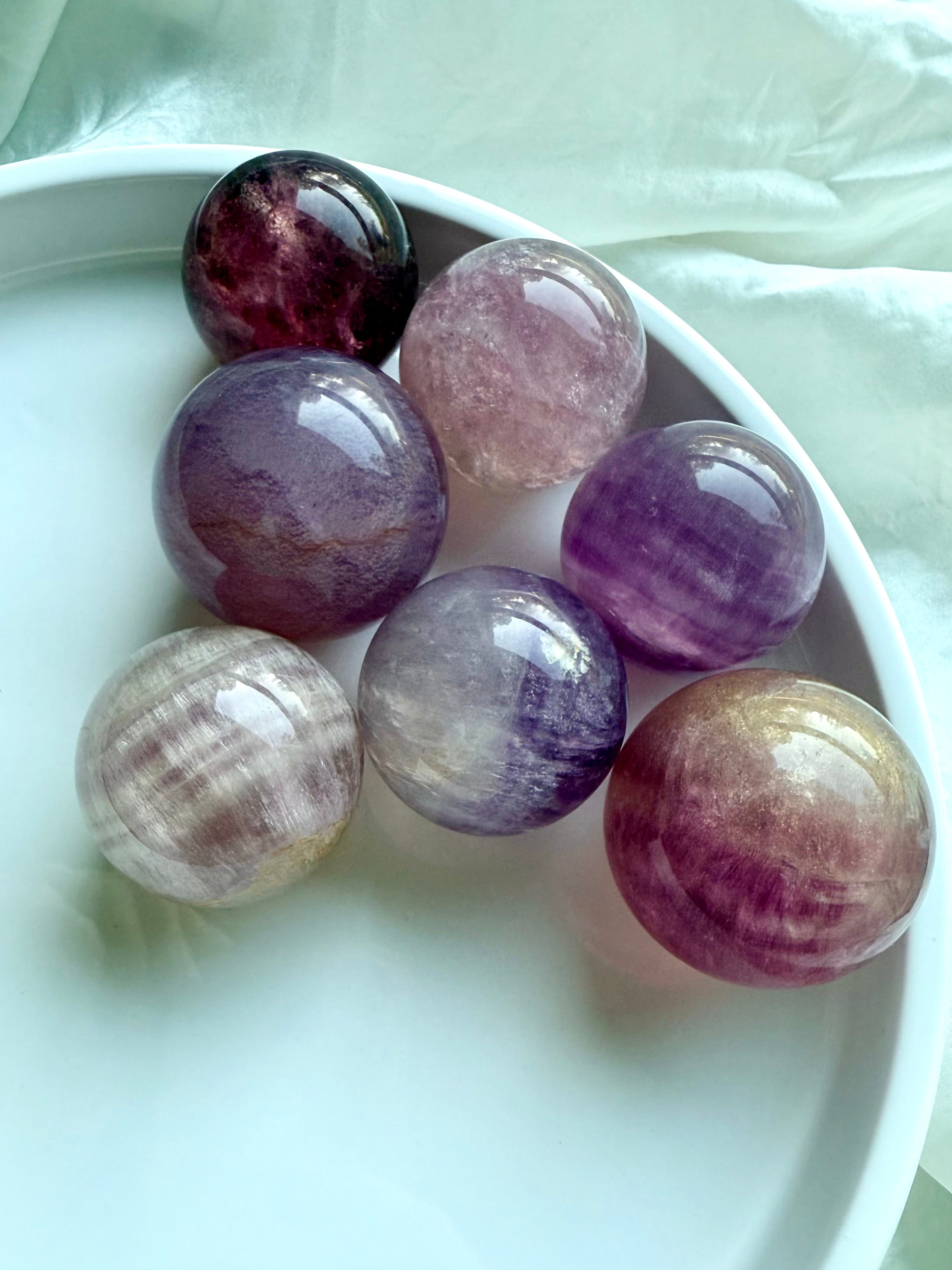 Silky Magenta Fluorite spheres in pastel pink and purple tones with natural banding for intuition and emotional healing