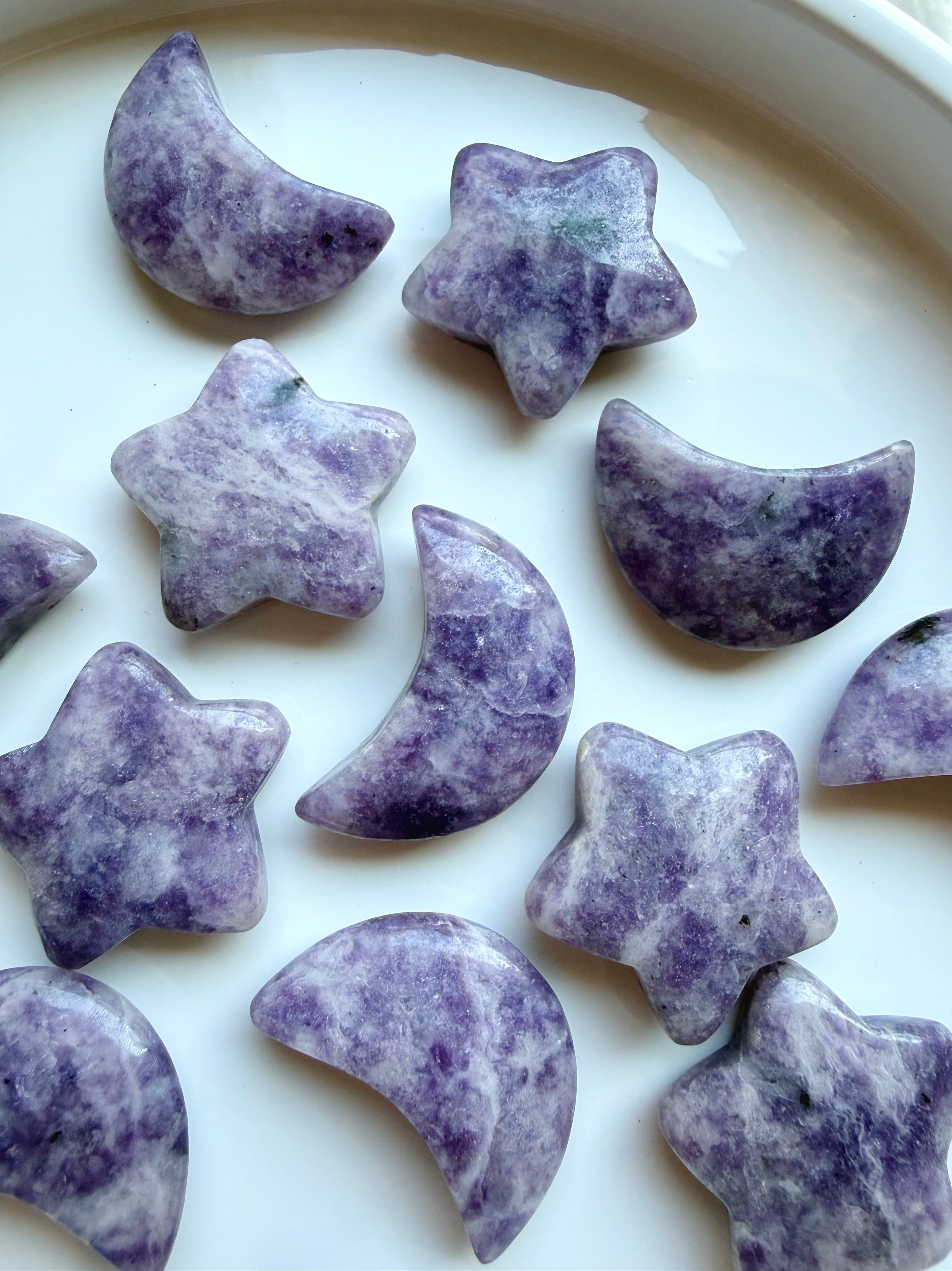 Polished Lepidolite moons and stars showing unique purple mineral patterns and natural variation in each crystal carving