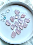 High-quality Madagascar Rose Quartz teardrops showing natural variation in pink color, clarity and translucence
