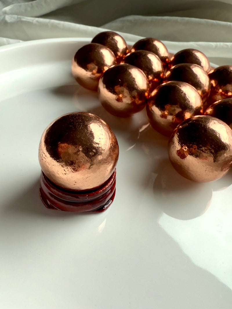 Michigan copper spheres shown in the simple wood stand option available in the dropdown menu