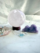 Lepidolite cloud carving displayed with Rose Quartz sphere and crystals for peaceful altar decor