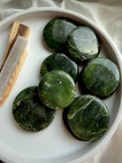 Nephrite jade palm stones with natural green marbling and black inclusions, polished flat stones for grounding energy work 