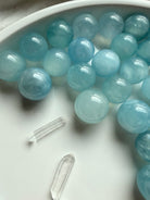 Assorted mini Aquamarine spheres in ocean blue tones – polished March birthstone crystal balls