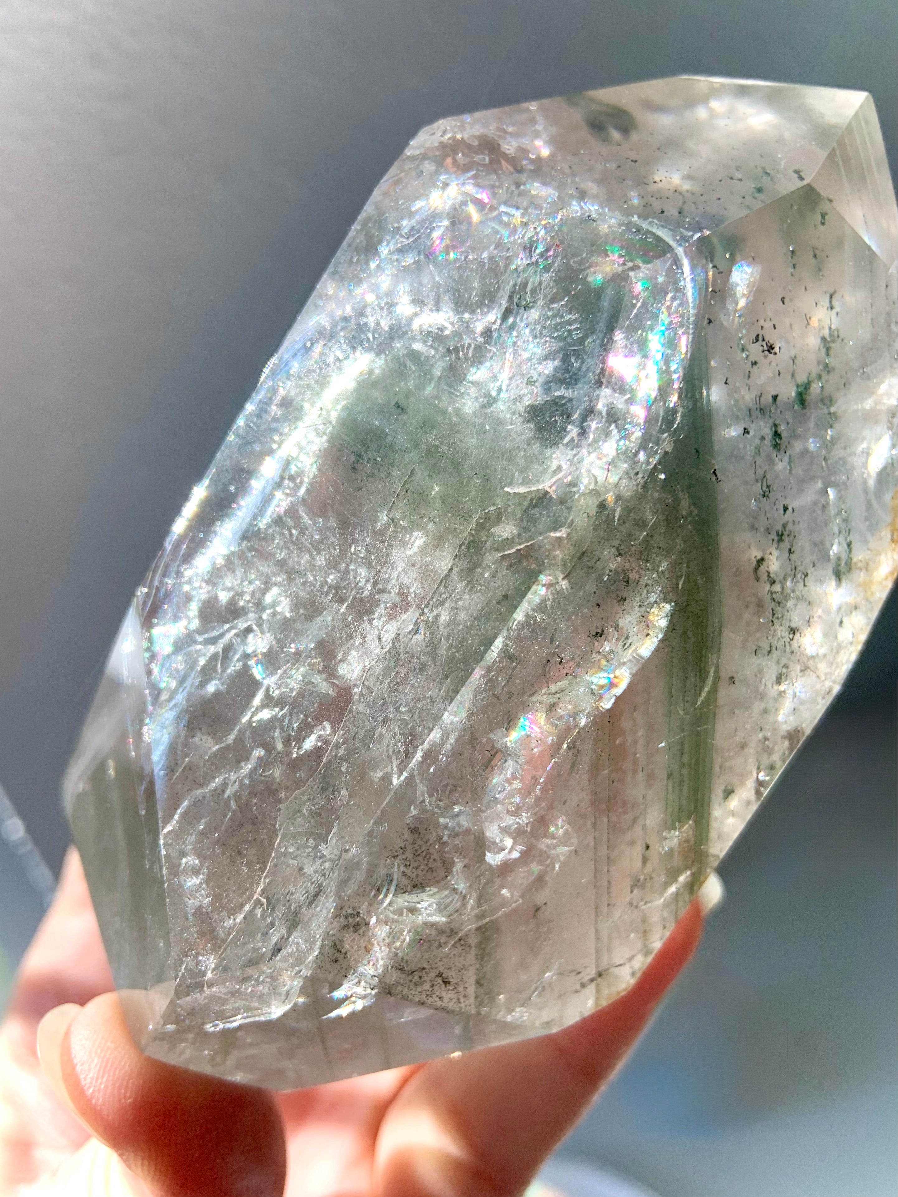 This Garden Quartz Crystal is filled with rainbows, chlorite phantoms, mossy mineral inclusions