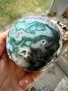 Moss Agate and Amethyst sphere showing polished crystal details with earthy green and purple colors