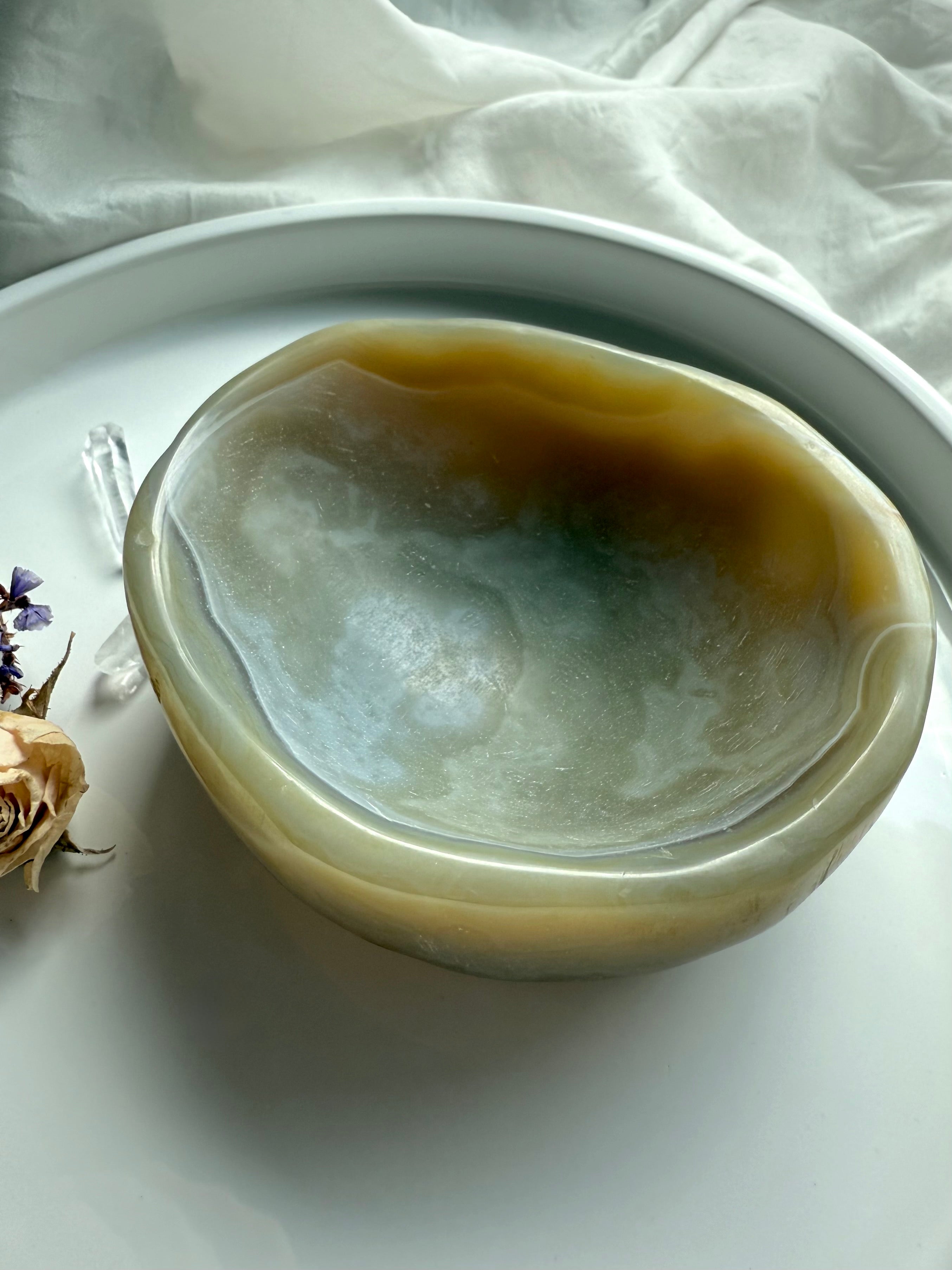 Top view of polished beige agate bowl with earthy banding – crystal dish for grounding and balance