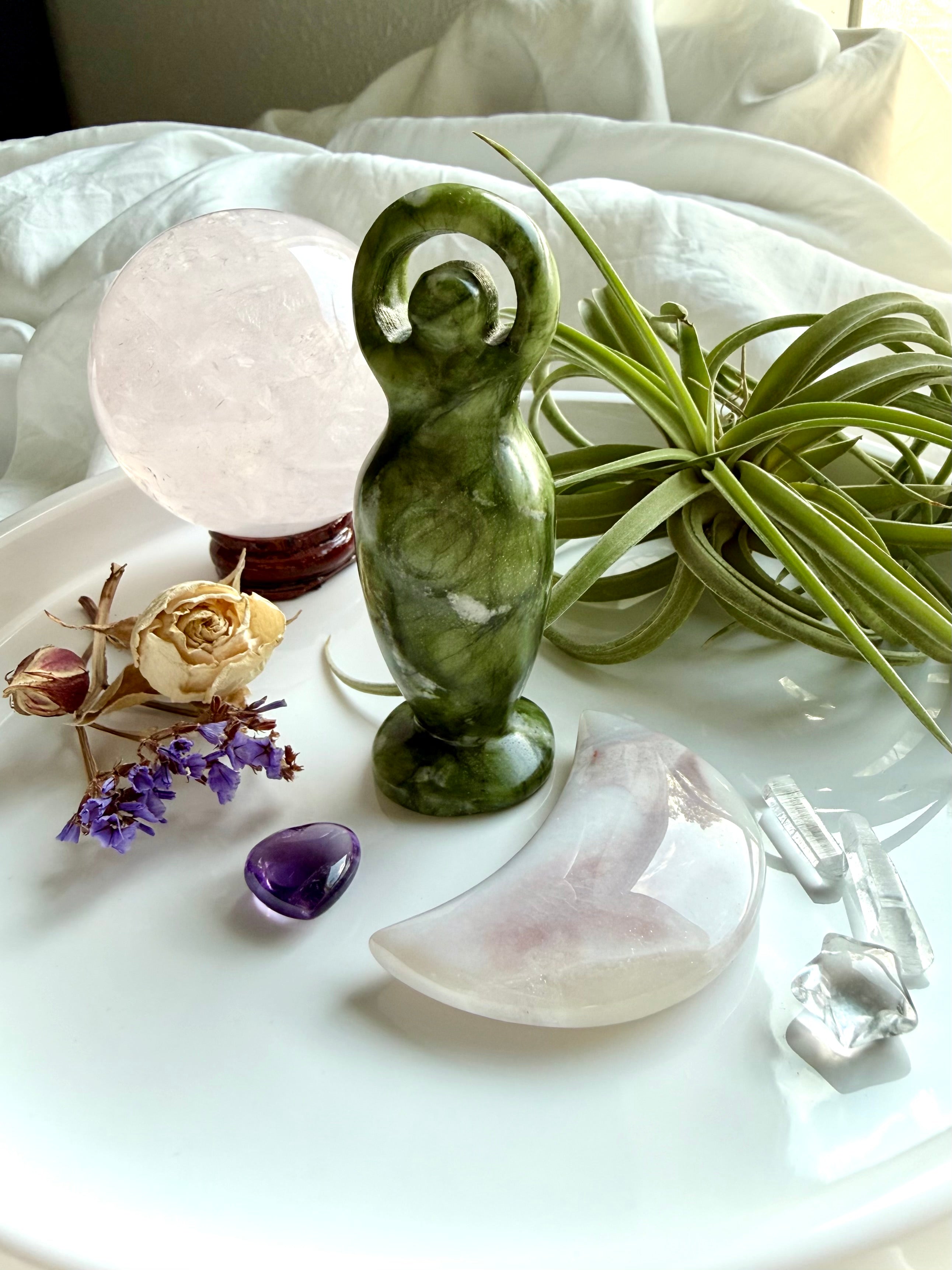 nephrite jade goddess figurine on altar with crystals and flowers, spiritual decor for protection grounding and divine feminine energy
