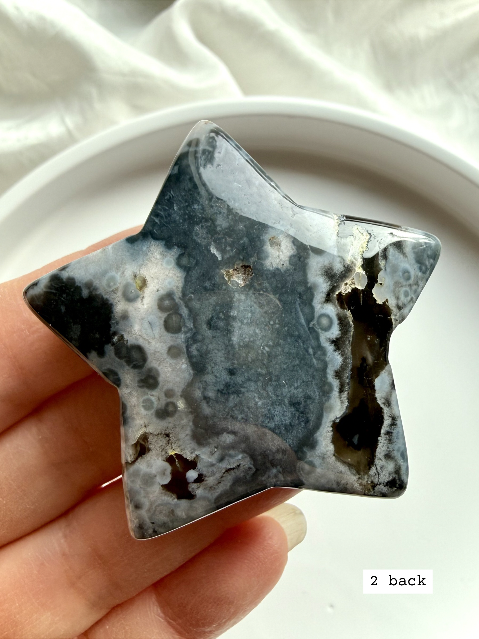 black flower agate star carving #2 back showing natural agate variation and soft bloom inclusions