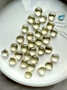 Polished Lemon Citrine heart crystals on a white tray with soft golden glow, Solar Plexus Chakra stone for joy, motivation, and abundance