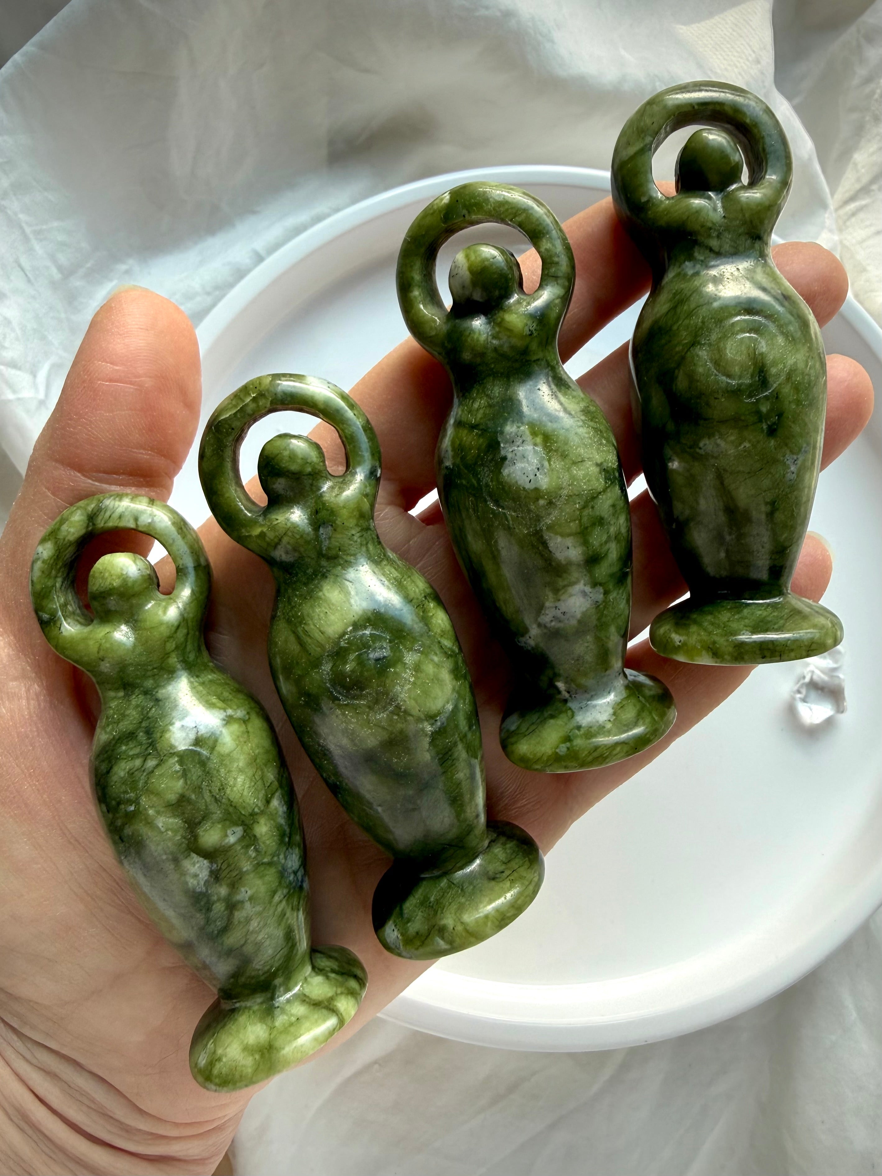 nephrite jade goddess carvings shown in hand for scale, natural green jade crystal figurines for grounding and protection