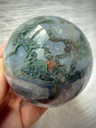 Moss Agate geode sphere with layered gray chalcedony, mossy green dendrites and sparkling natural Quartz crystals