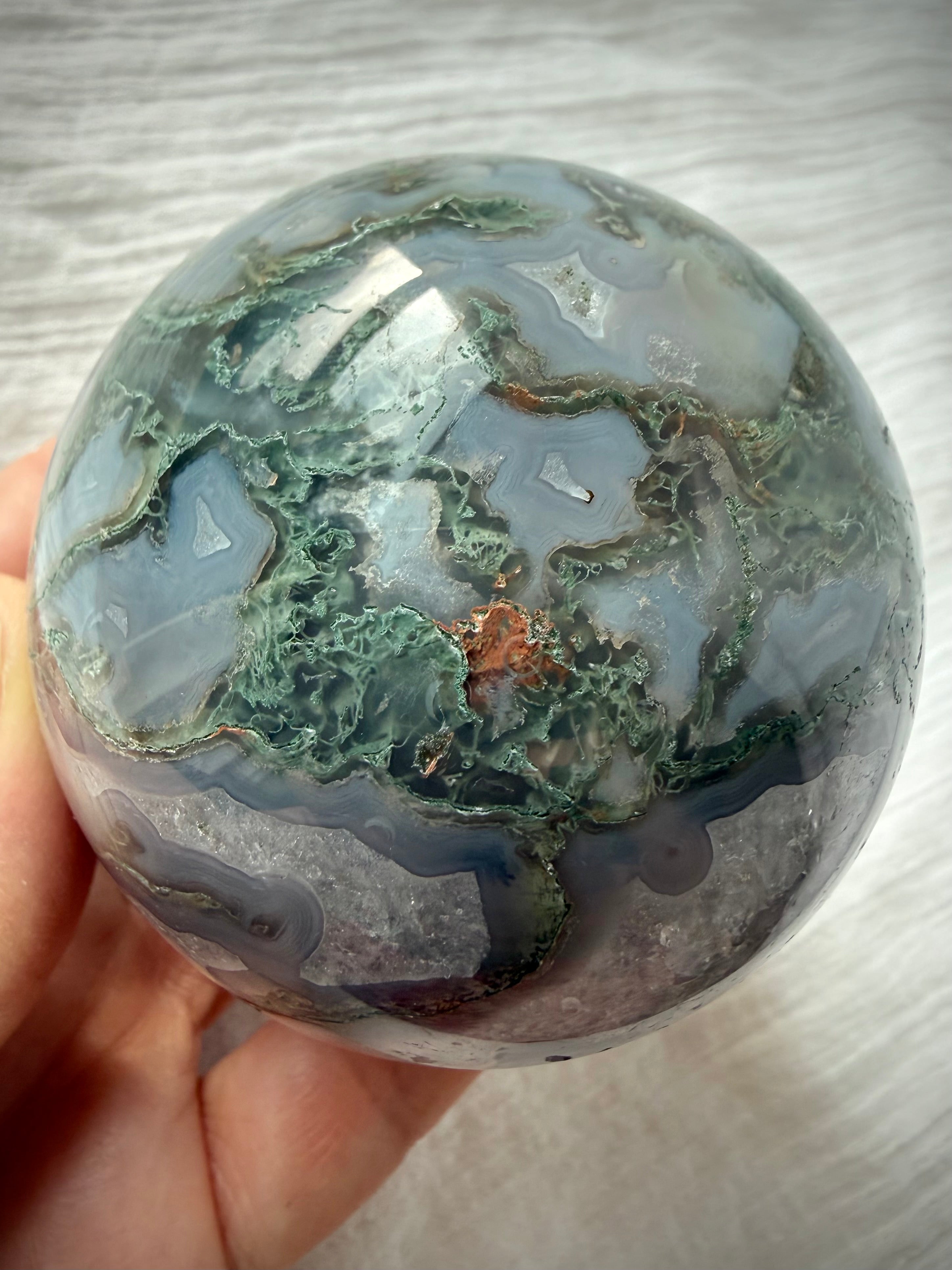 Moss Agate geode sphere with layered gray chalcedony, mossy green dendrites and sparkling natural Quartz crystals