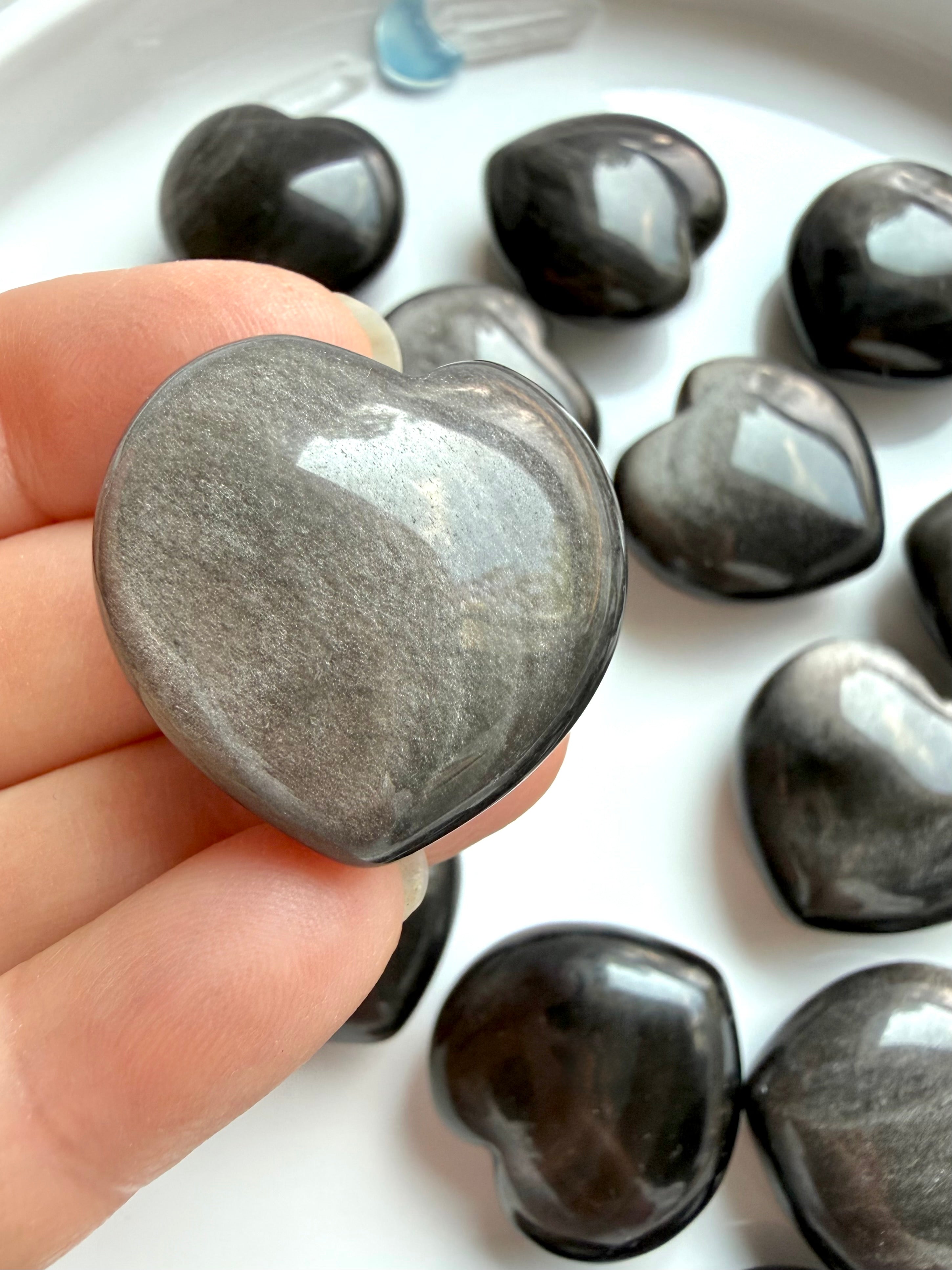 Close-up Silver Sheen Obsidian heart showing concentrated silver sheen and smooth high-gloss polish