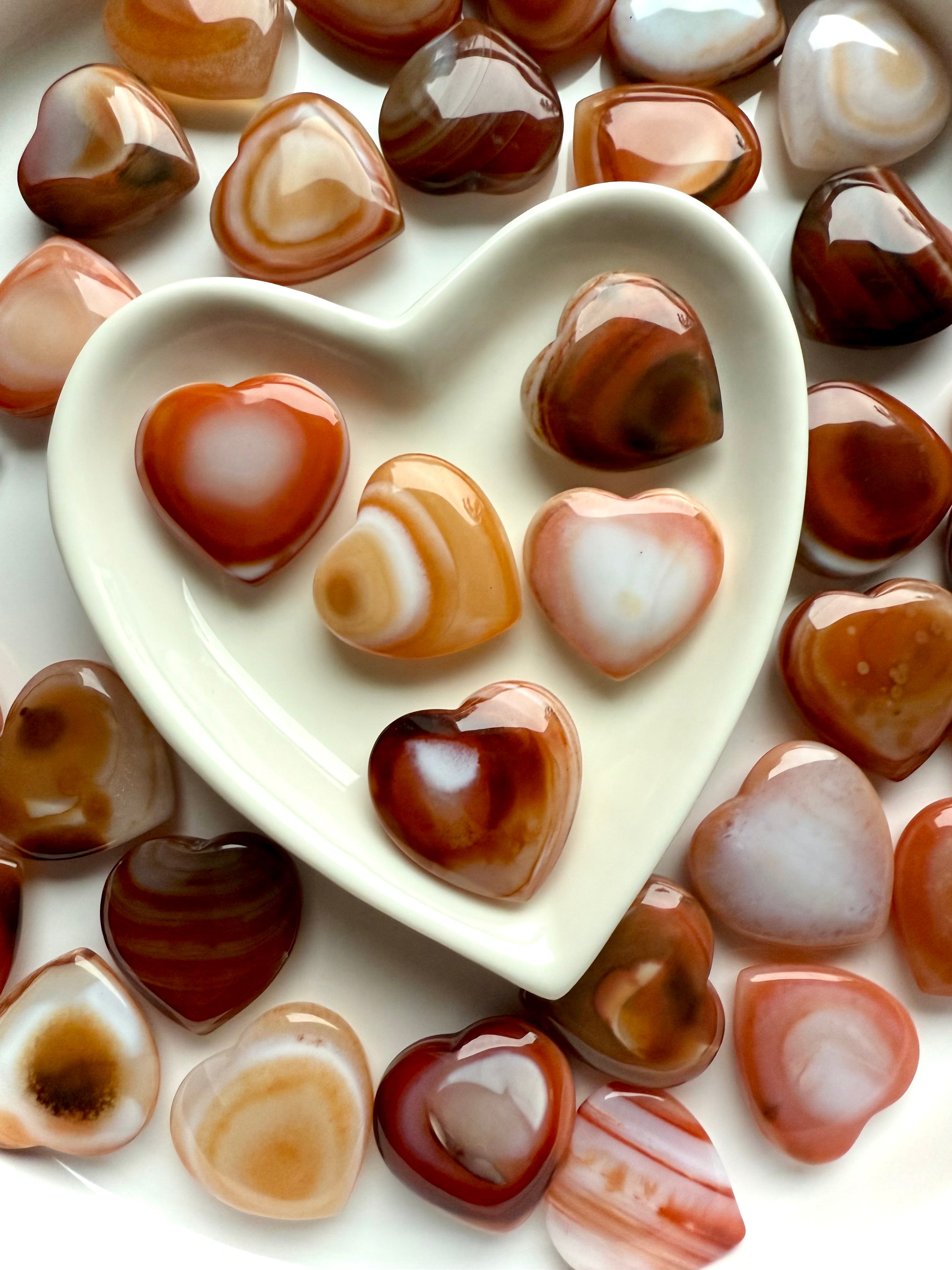 Mini Carnelian Hearts styled in ceramic heart bowl, Sacral Chakra crystals for ritual and meditation