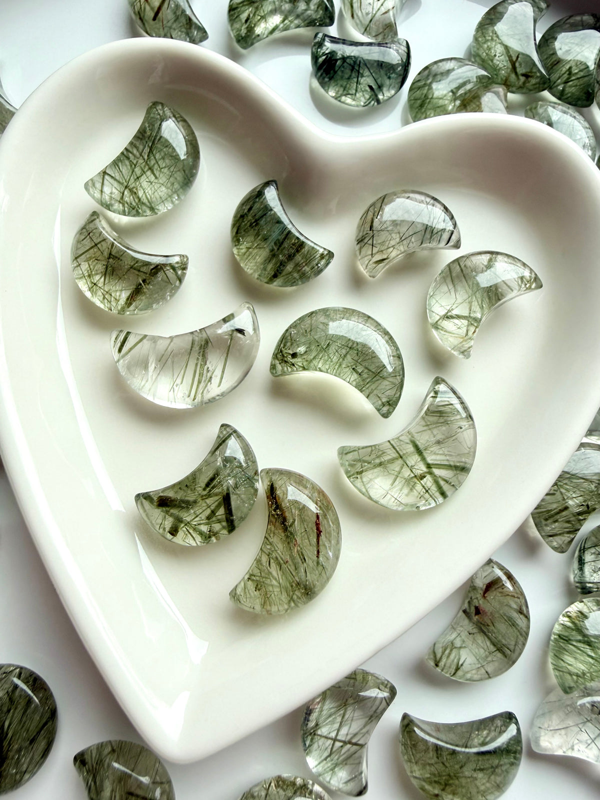 Mini Tourmalinated Quartz moons with green tourmaline needles arranged in a heart-shaped crystal dish