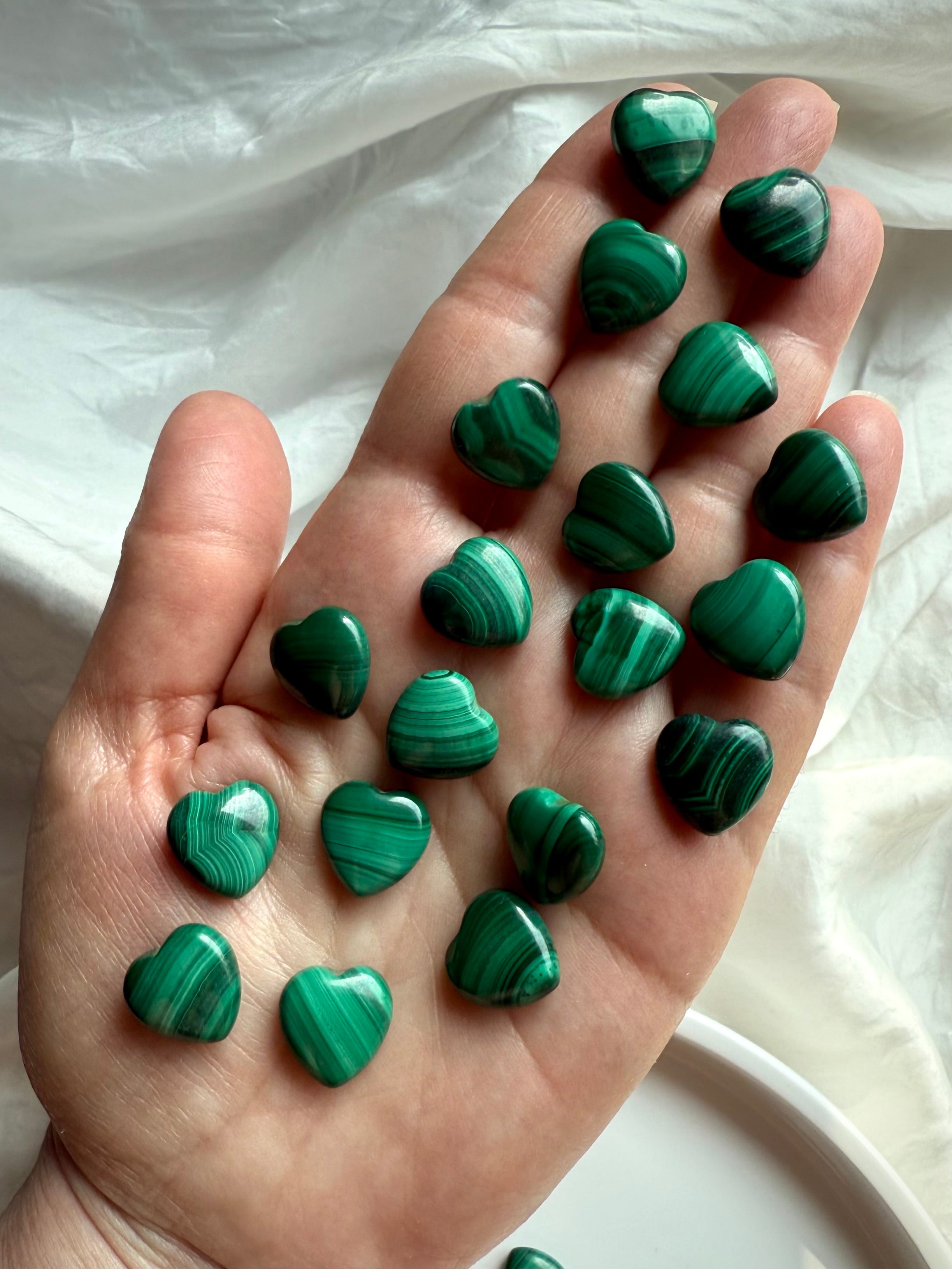 High-quality Mini Malachite crystal hearts displayed in hand showing natural green banding and swirling patterns
