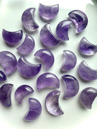 Polished amethyst crescent moons showing natural lavender to deep purple color variation