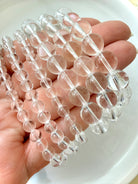 High clarity Clear Quartz bracelets displayed in hand showing transparent polished crystal beads