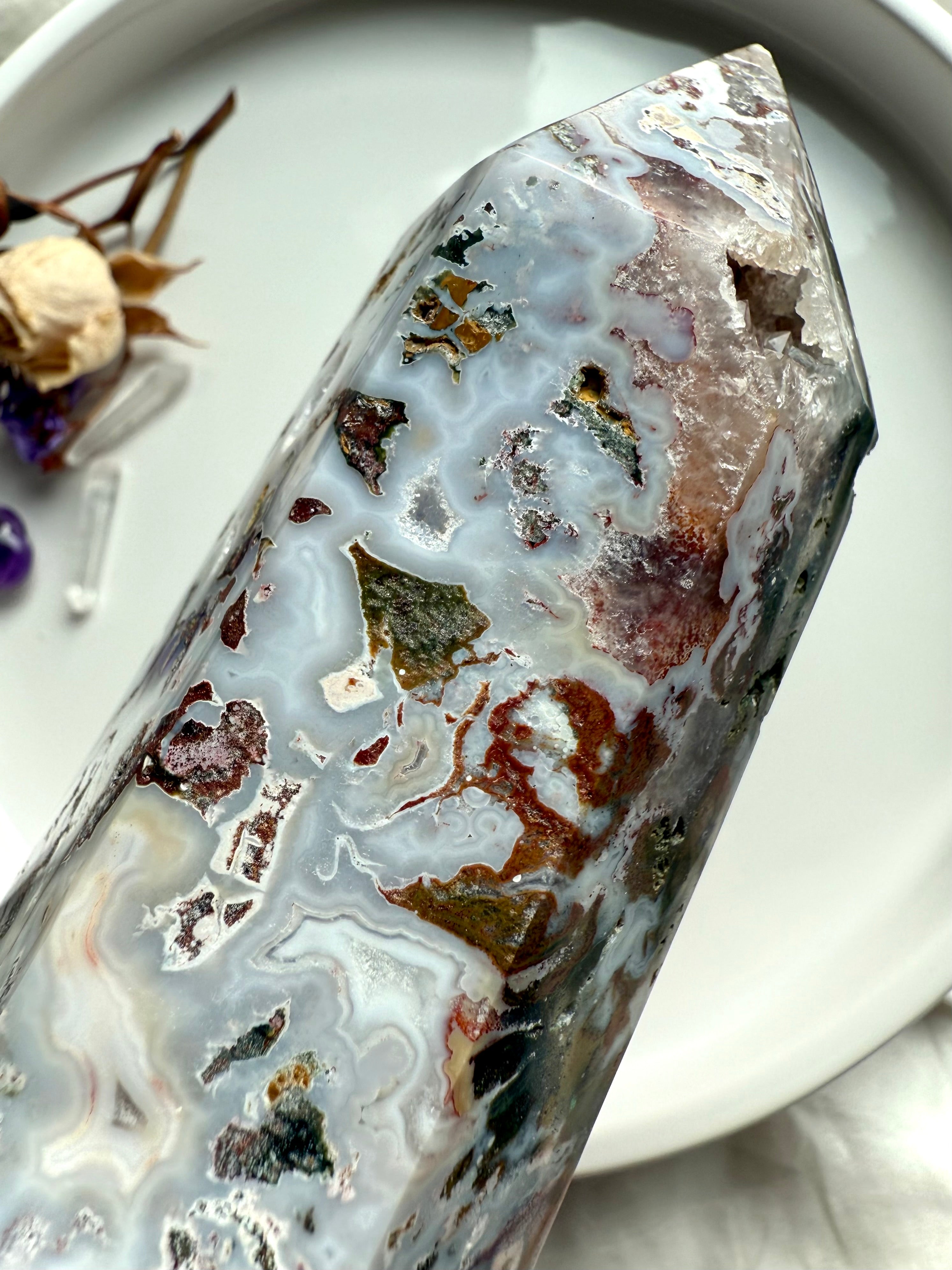 Pointed tip of Cosmic Ocean Jasper crystal tower highlighting translucent chalcedony layers and subtle druzy texture