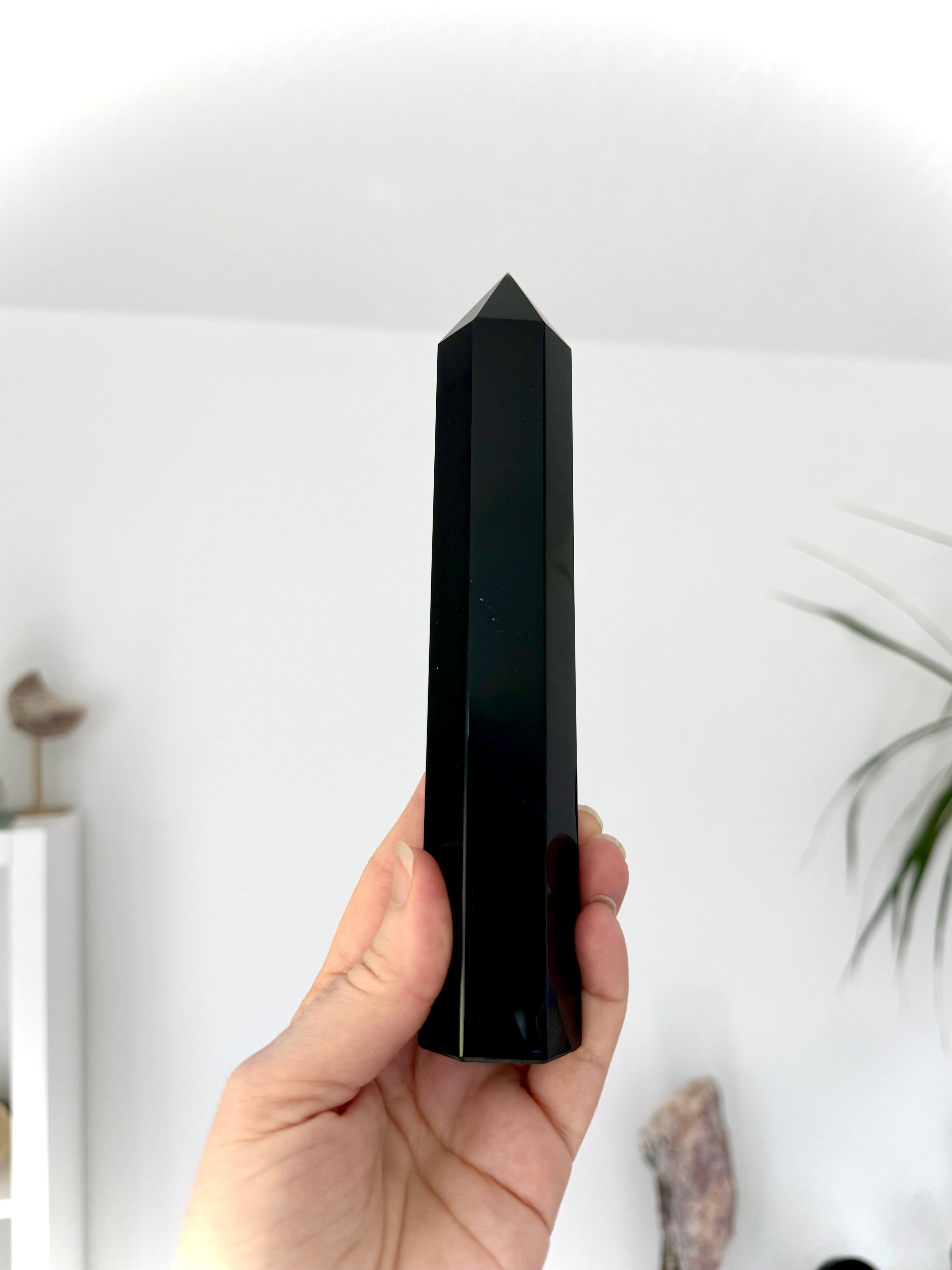 Large Black Obsidian tower held upright — polished Root Chakra crystal for clarity & protection.