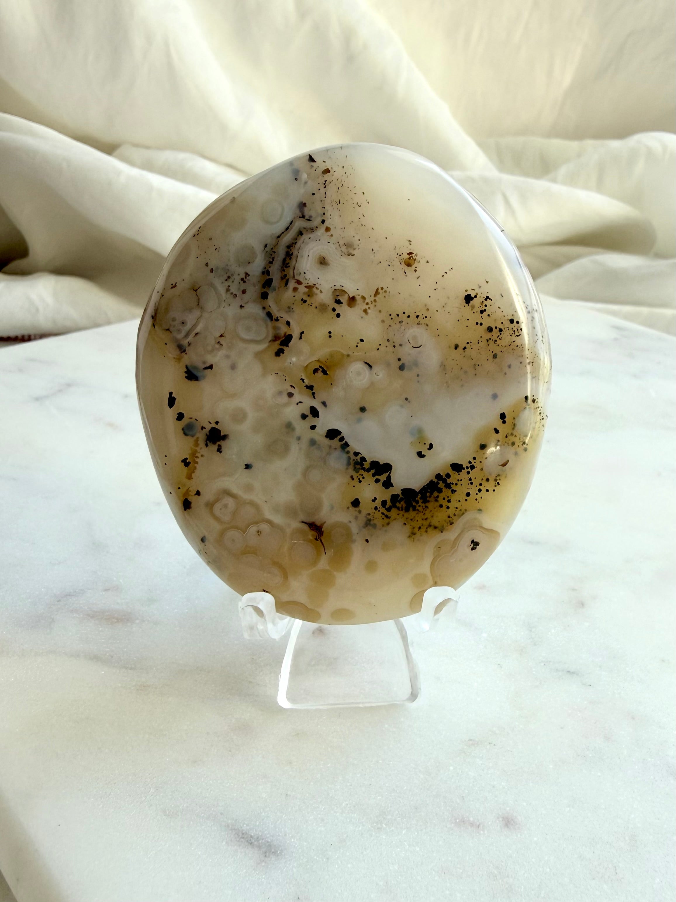 Dendritic Agate crystal on stand, showing cream-colored Agate and intricate natural dendritic patterns, reverse side