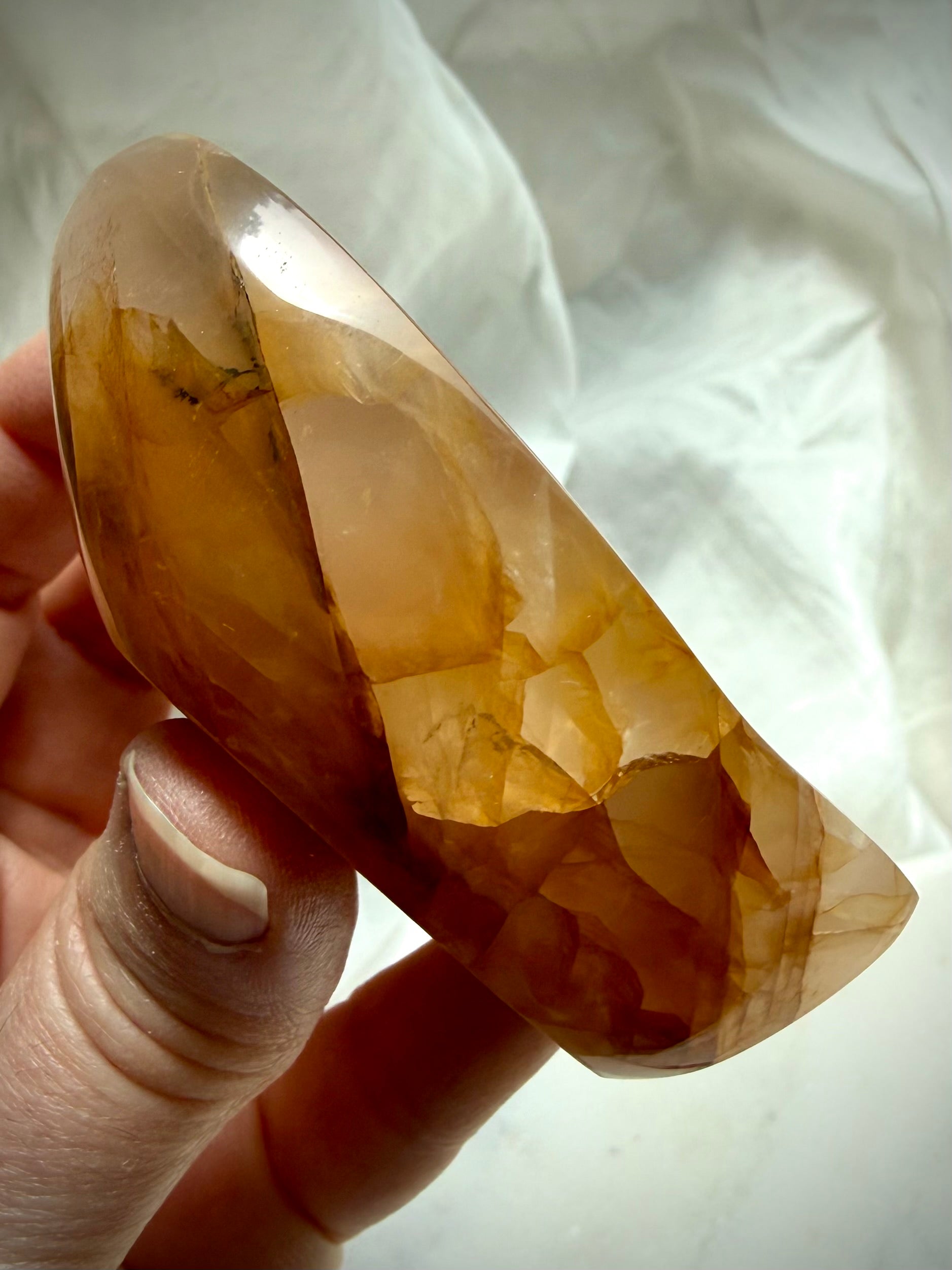 Side profile of Golden Healer Quartz teardrop bowl showing thickness and polished crystal edges