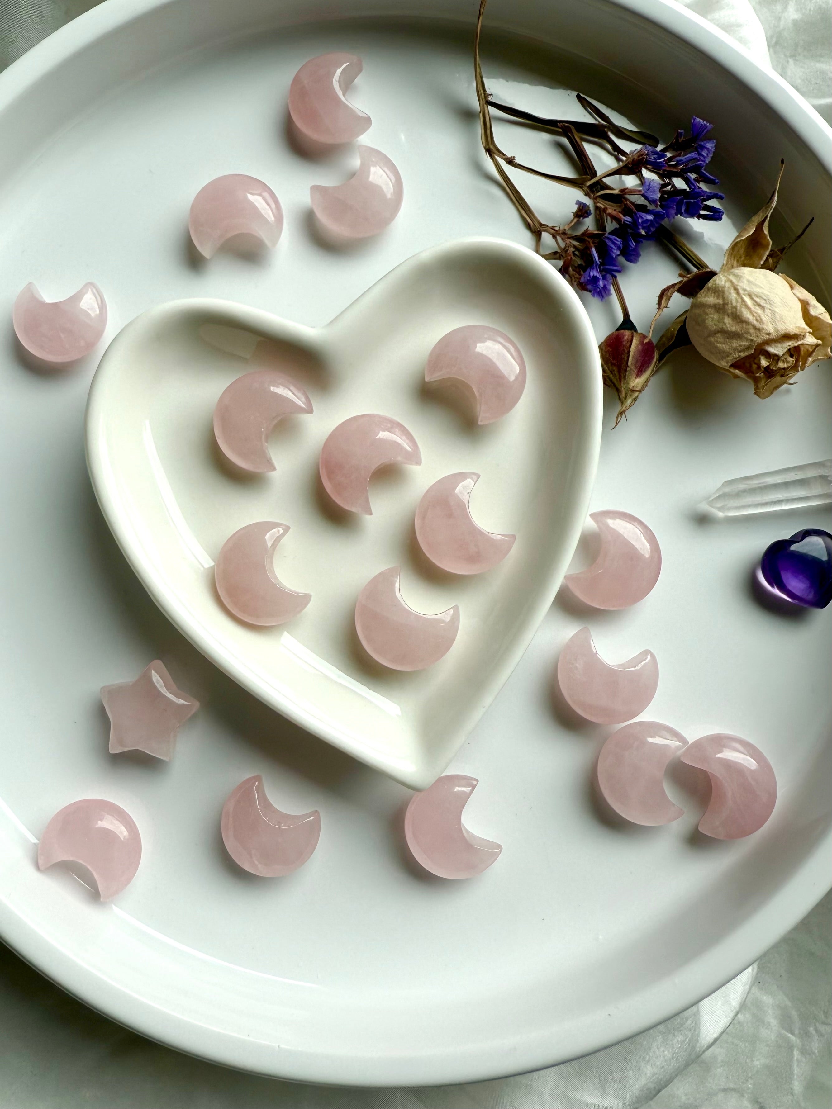 Mini Rose Quartz moon carvings on white. Heart Chakra crystals for emotional healing, love, & peaceful bedroom décor.
