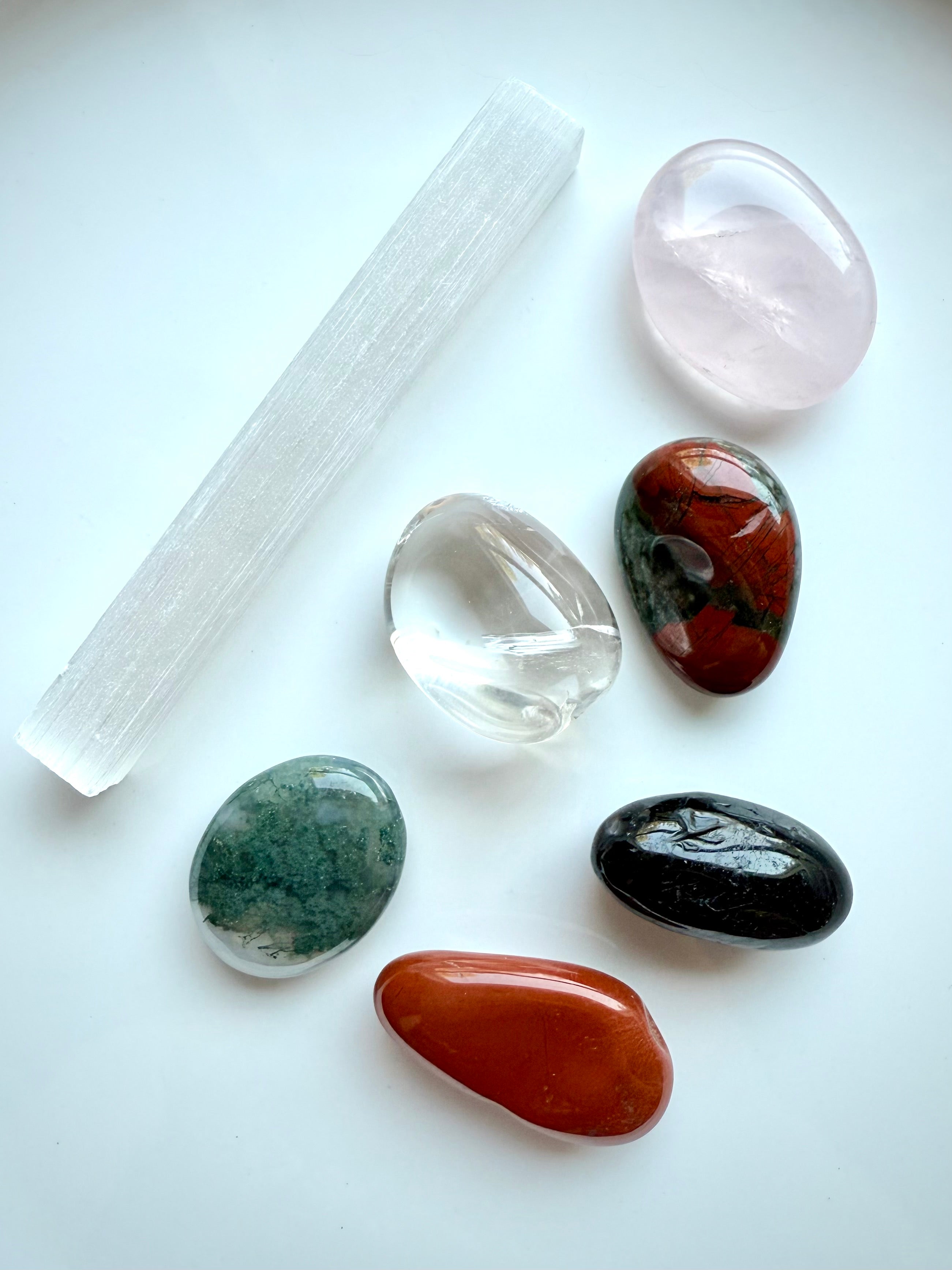 Get Well healing crystals shown on white background, including Selenite and Rose Quartz