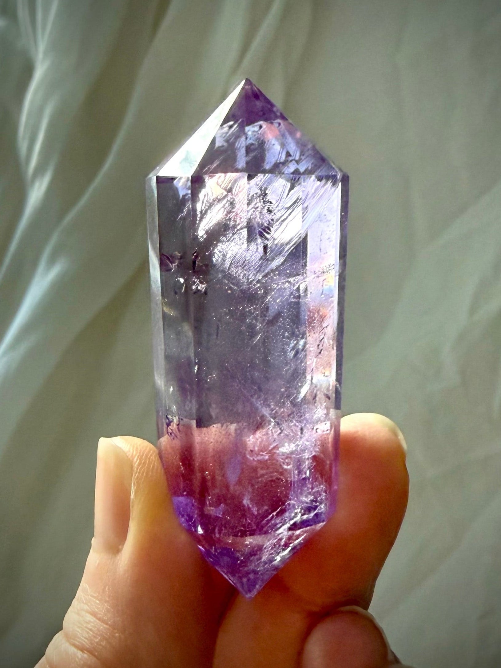 High-clarity Amethyst Vogel cut wand with polished facets and vibrant purple tones