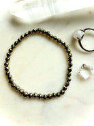 faceted pyrite bracelet styled flat with matching jewelry set showing minimalist crystal bracelet design