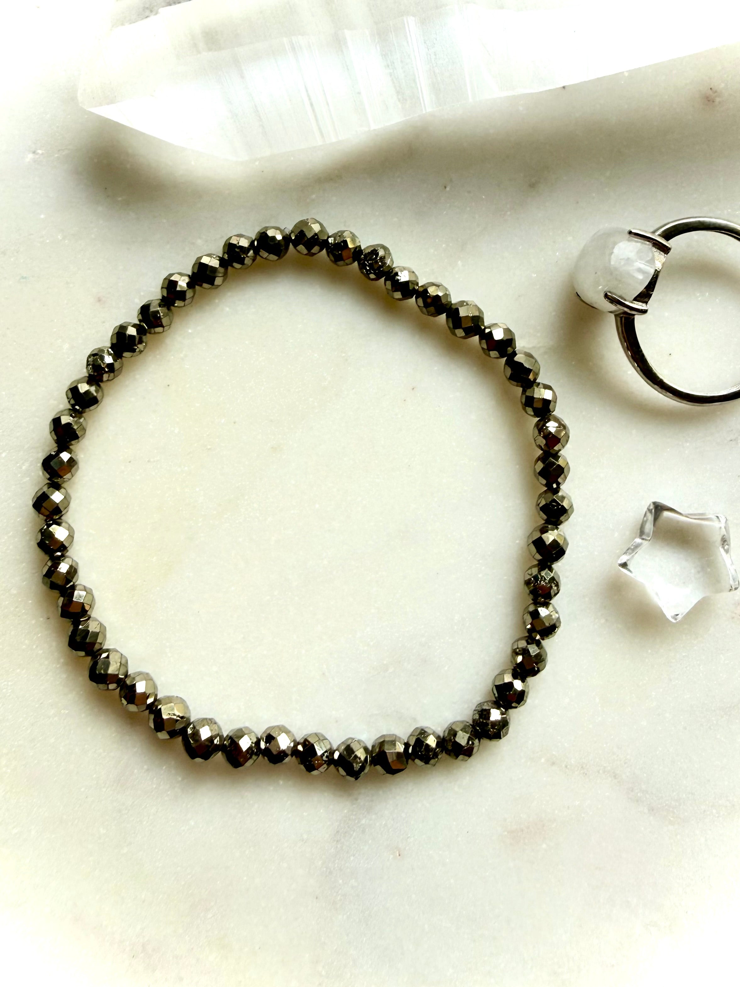 faceted pyrite bracelet styled flat with matching jewelry set showing minimalist crystal bracelet design