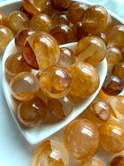 collection of golden healer quartz mini spheres with blended amber tones and internal veiling