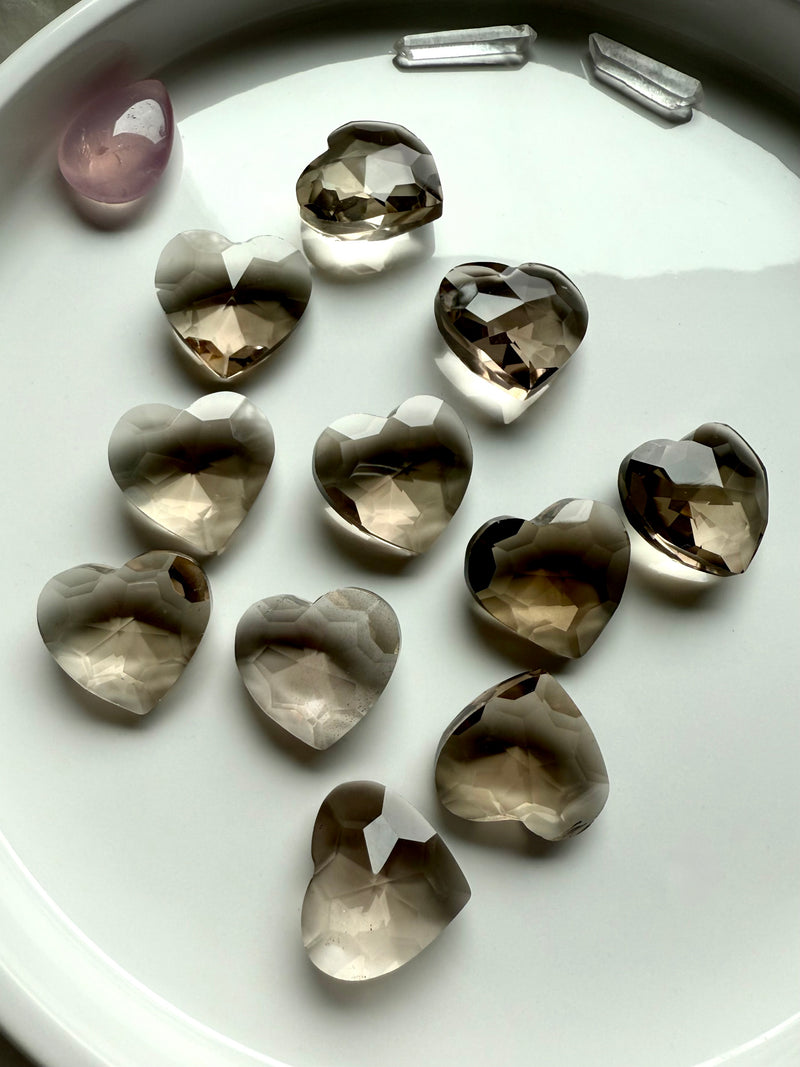 Gem Cut Smokey Quartz Hearts shown on a white plate, photographed in natural light