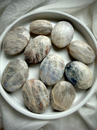 collection of russian moonstone palm stones with natural shimmer and intuitive lunar energy