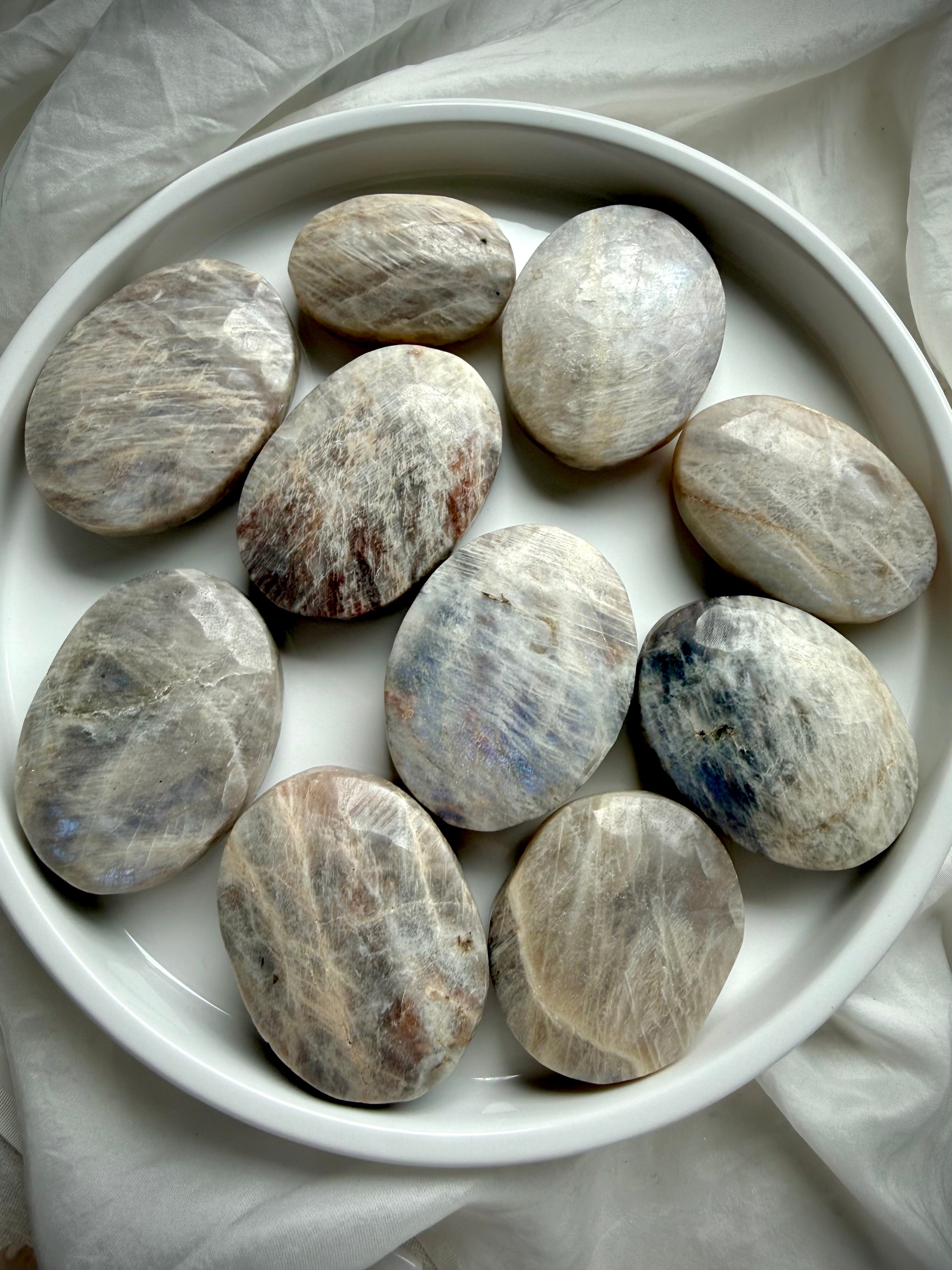 collection of russian moonstone palm stones with natural shimmer and intuitive lunar energy