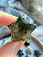 close-up moss agate star showing detailed green dendritic inclusions and translucent chalcedony for grounding and Gaia connection