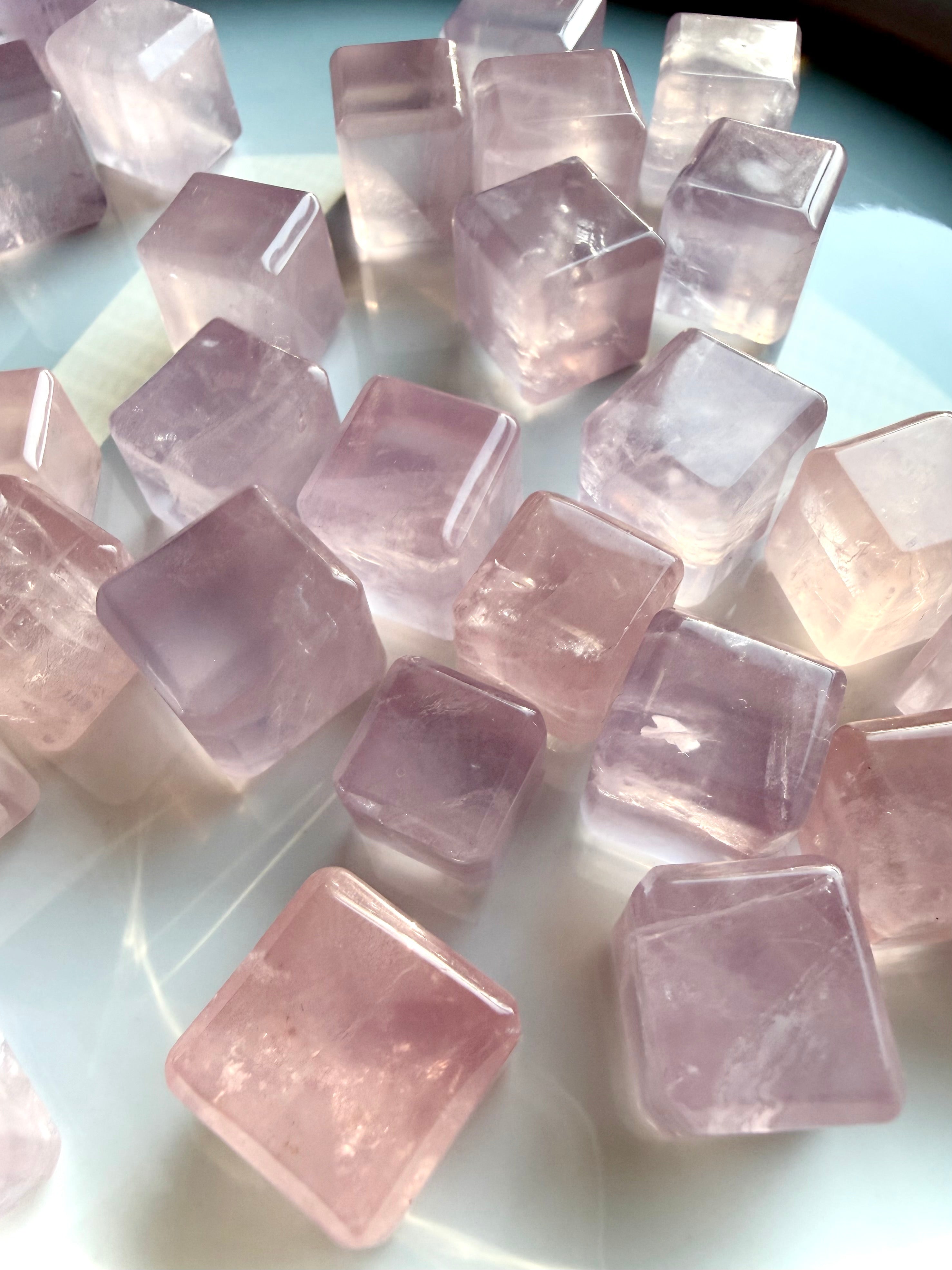 Closeup of mini rose quartz cubes pocket stone for self love, emotional balance, and calming energy
