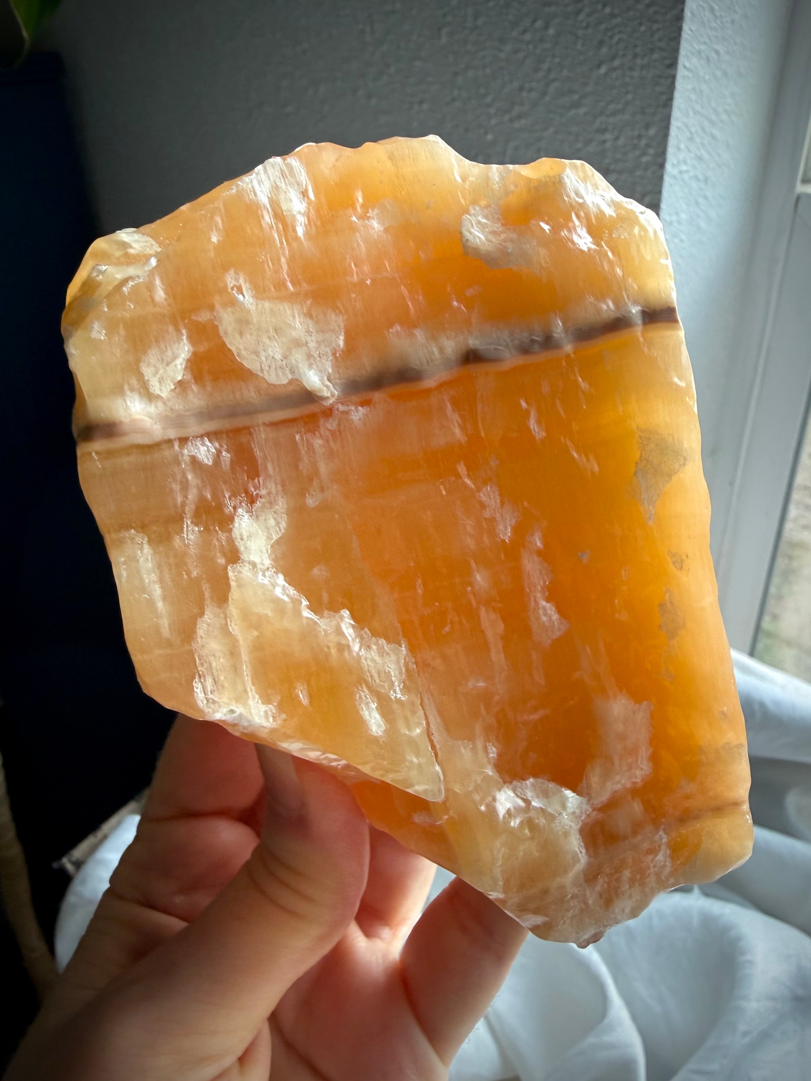 Self-standing Orange Calcite display piece from Mexico with translucent orange coloration and natural mineral layers