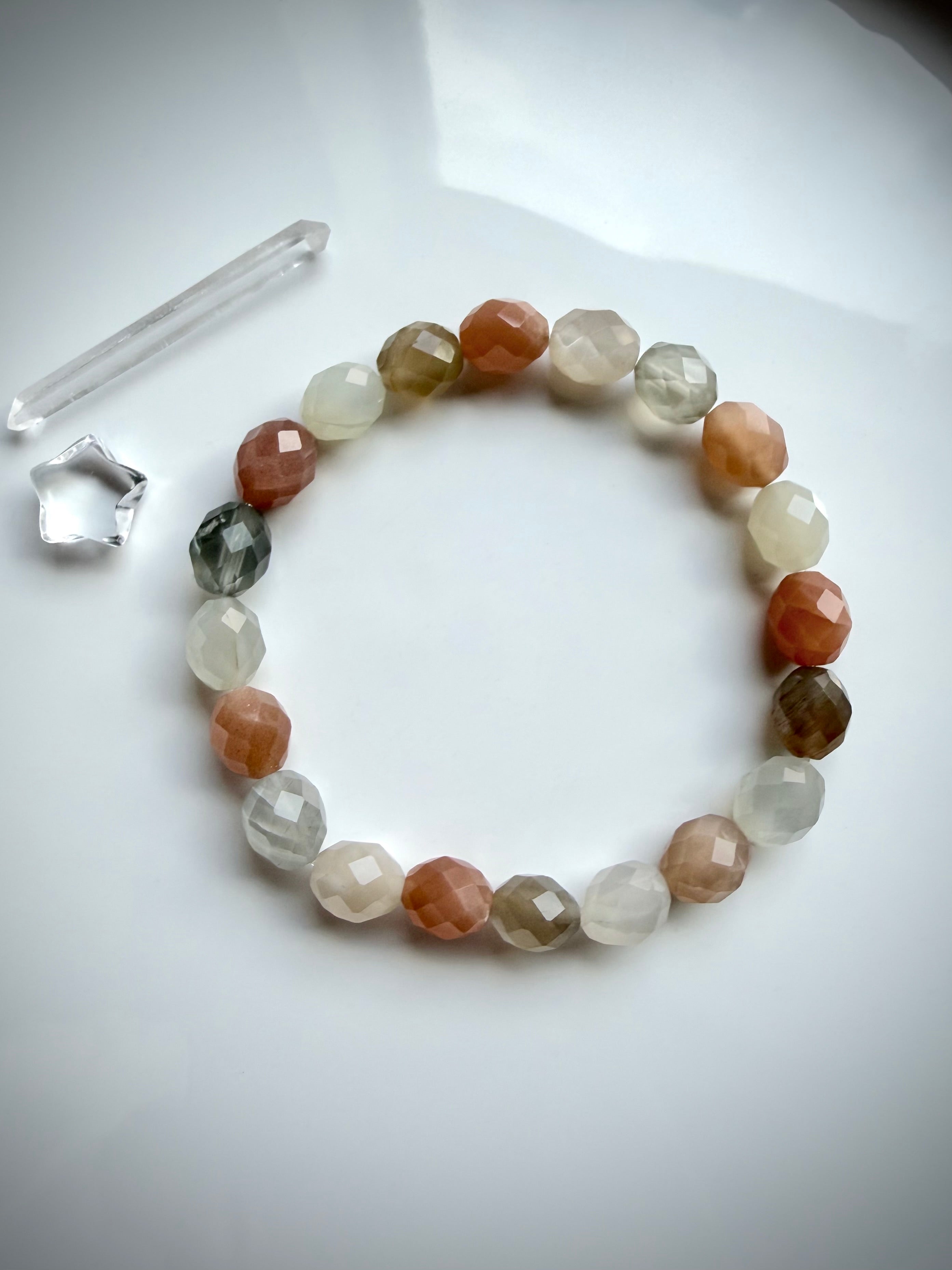 Faceted Moonstone stretch bracelet with multicolor oval gemstone beads in peach, champagne, gray, and creamy white