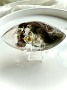 Scenic Garden Quartz crystal lens with mossy inclusions and golden healer tones on white tray