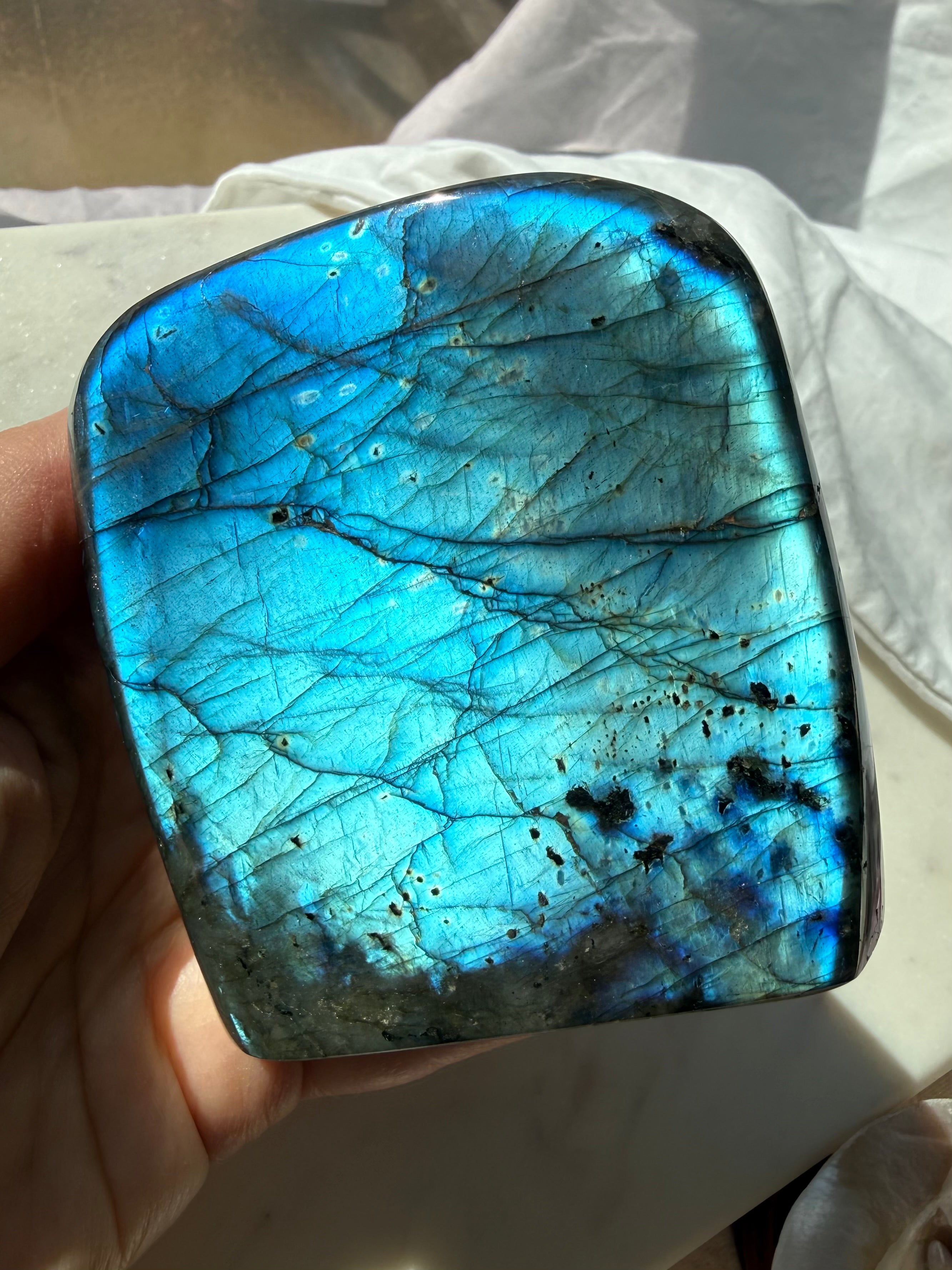 Full flash Labradorite freeform showing brilliant aqua and electric blue labradorescence in sunlight