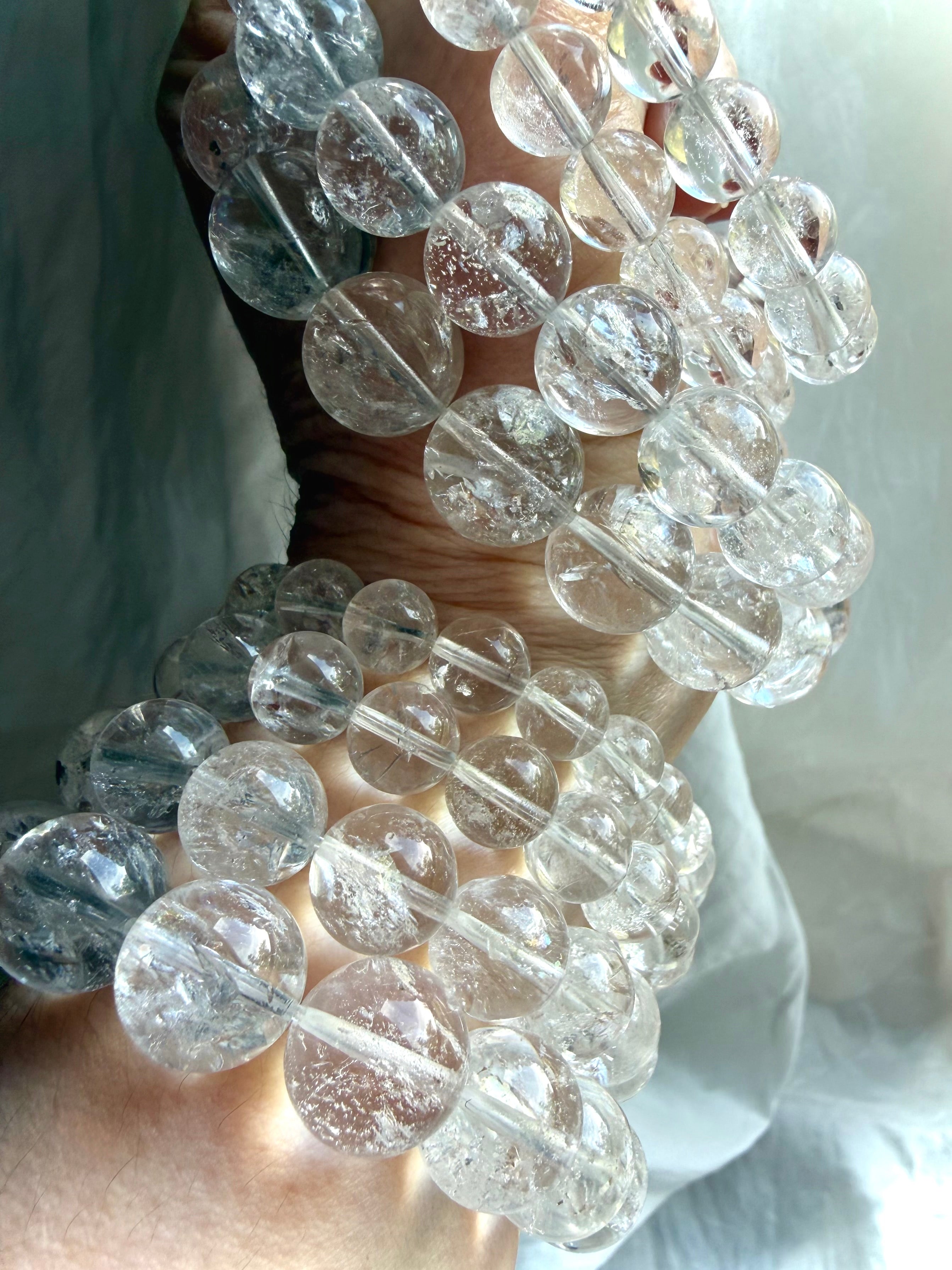 Layered Rainbow Quartz bracelets with glossy polished crystal beads and luxe stacking style